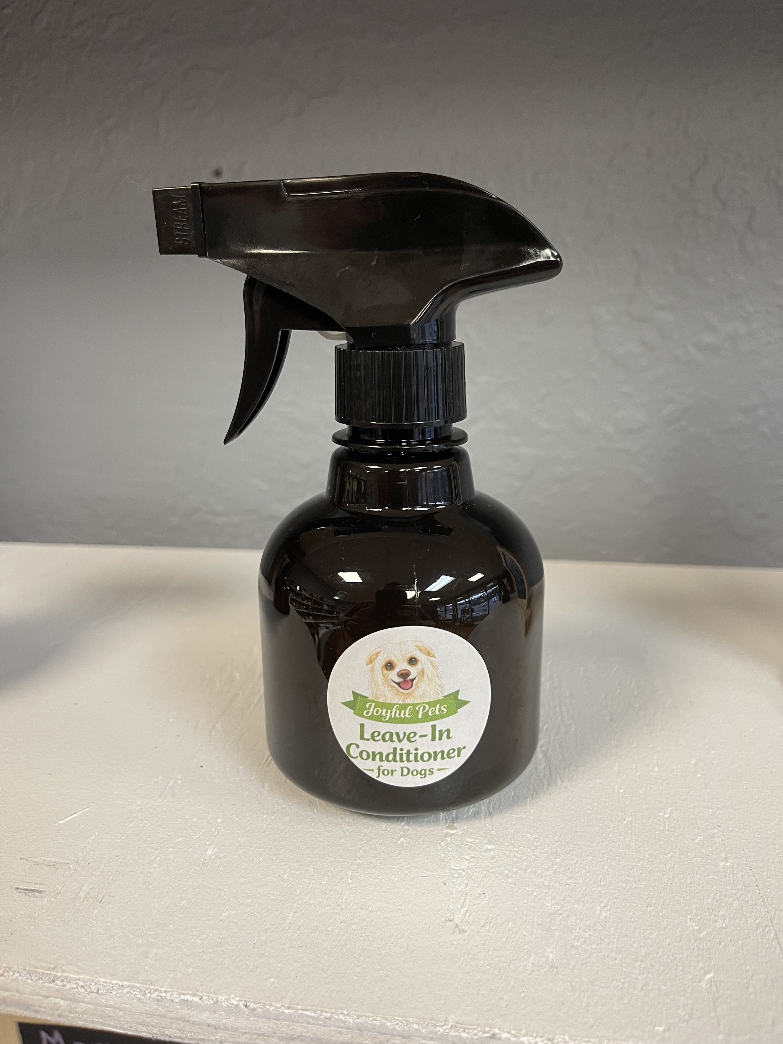 An image of a bottle of leave-in conditioner that was made by Courtney at Joyful Pets