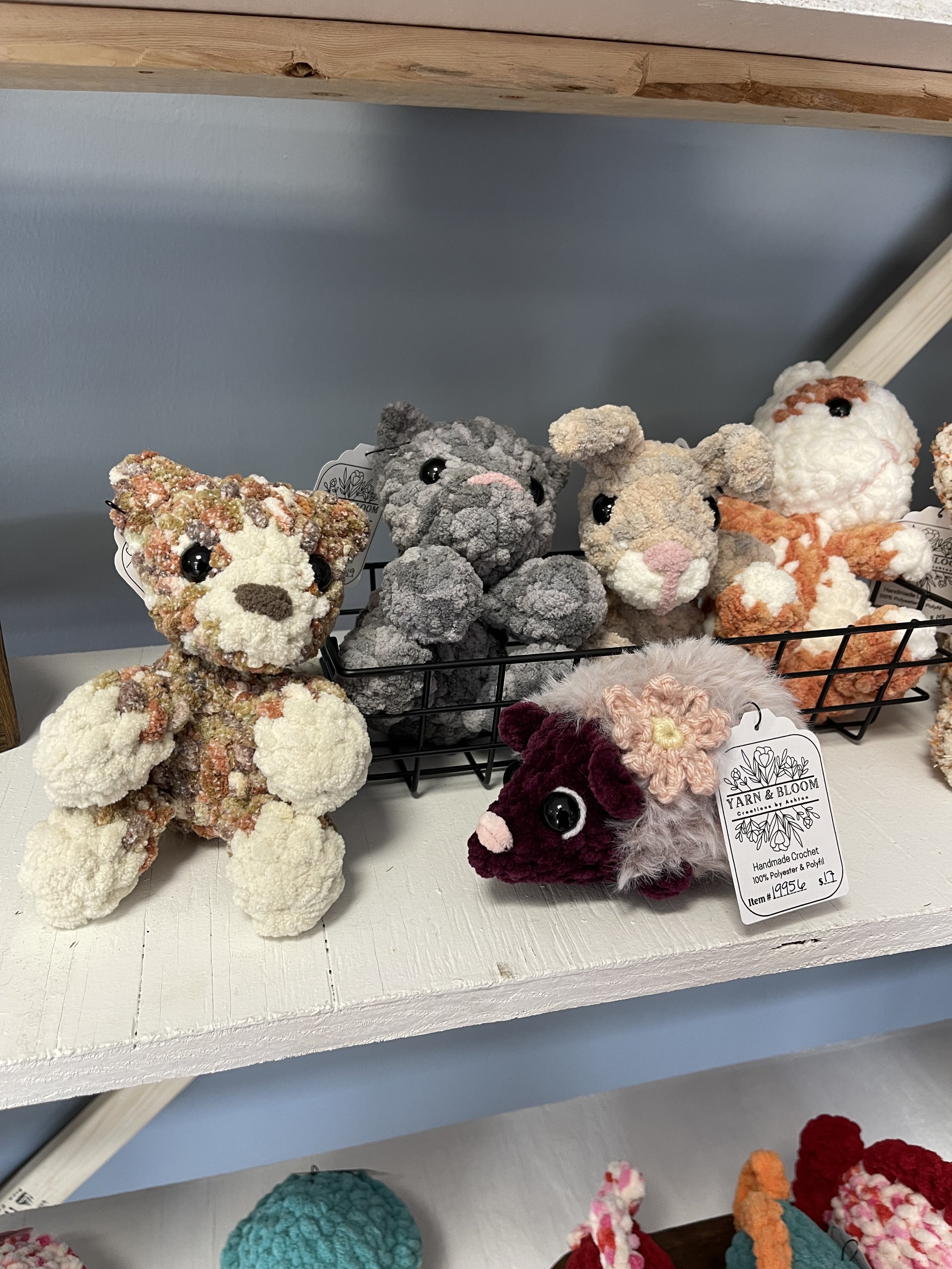 Image of some cute crocheted animals sitting together on a shelf