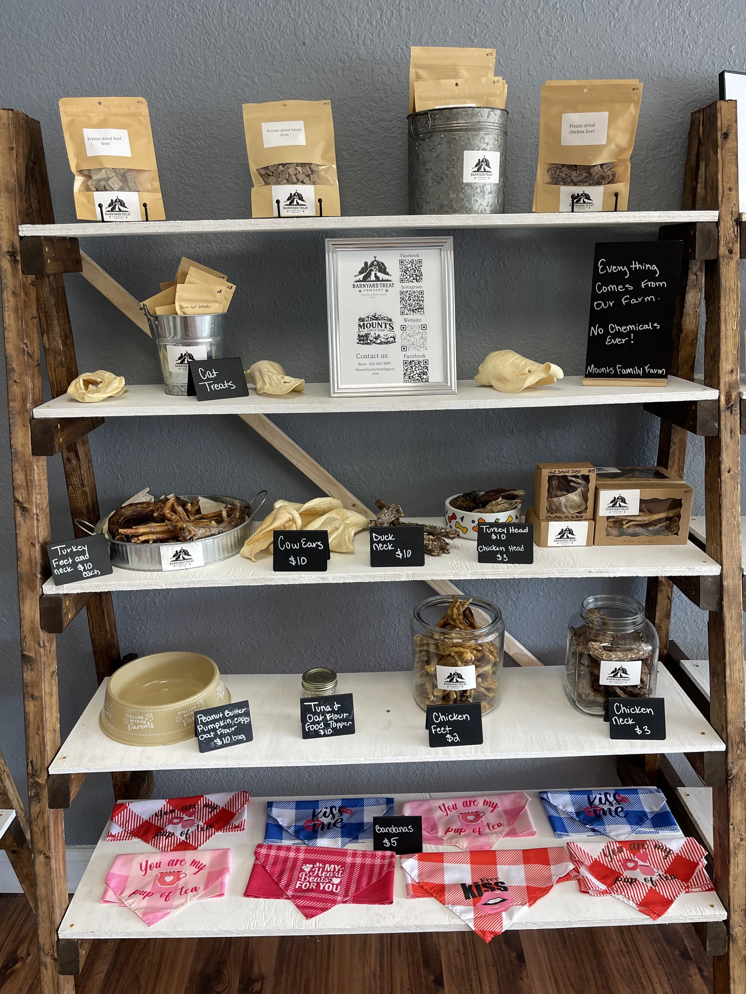 A shelving unit with dog and cat treats made by Barnyard Treat Company
