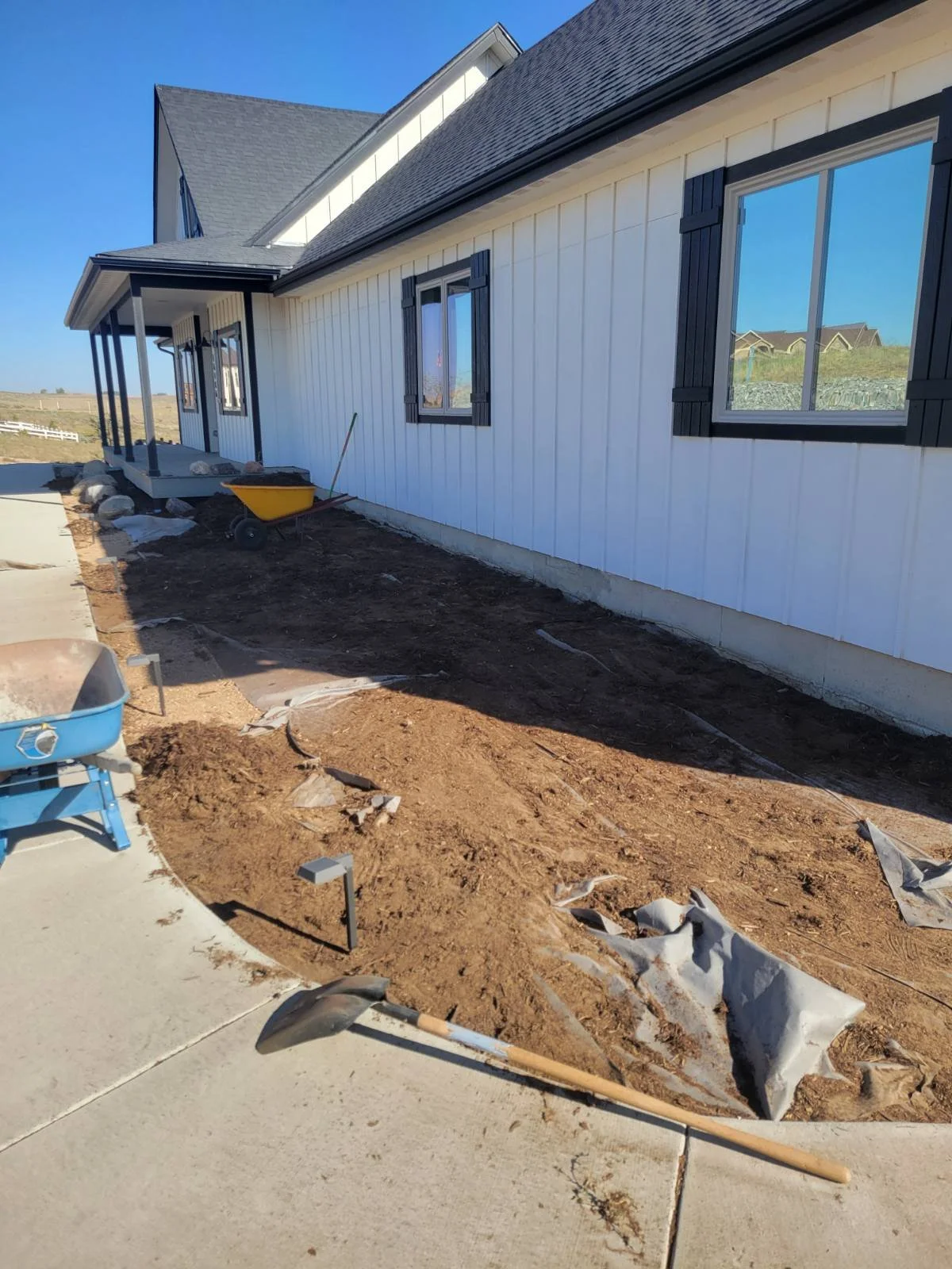 Removing old compacted mulch and ripped weed barrier. Refreshing with new fabric and black mulch. 