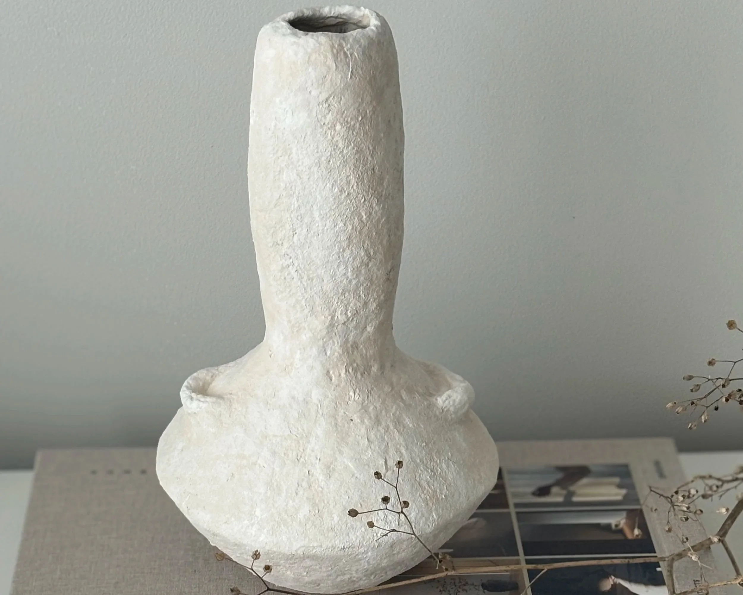 White Textured Vase N.17, white paper clay vase viewed from an alternate angle highlighting asymmetrical shape, from Papier Atelier London