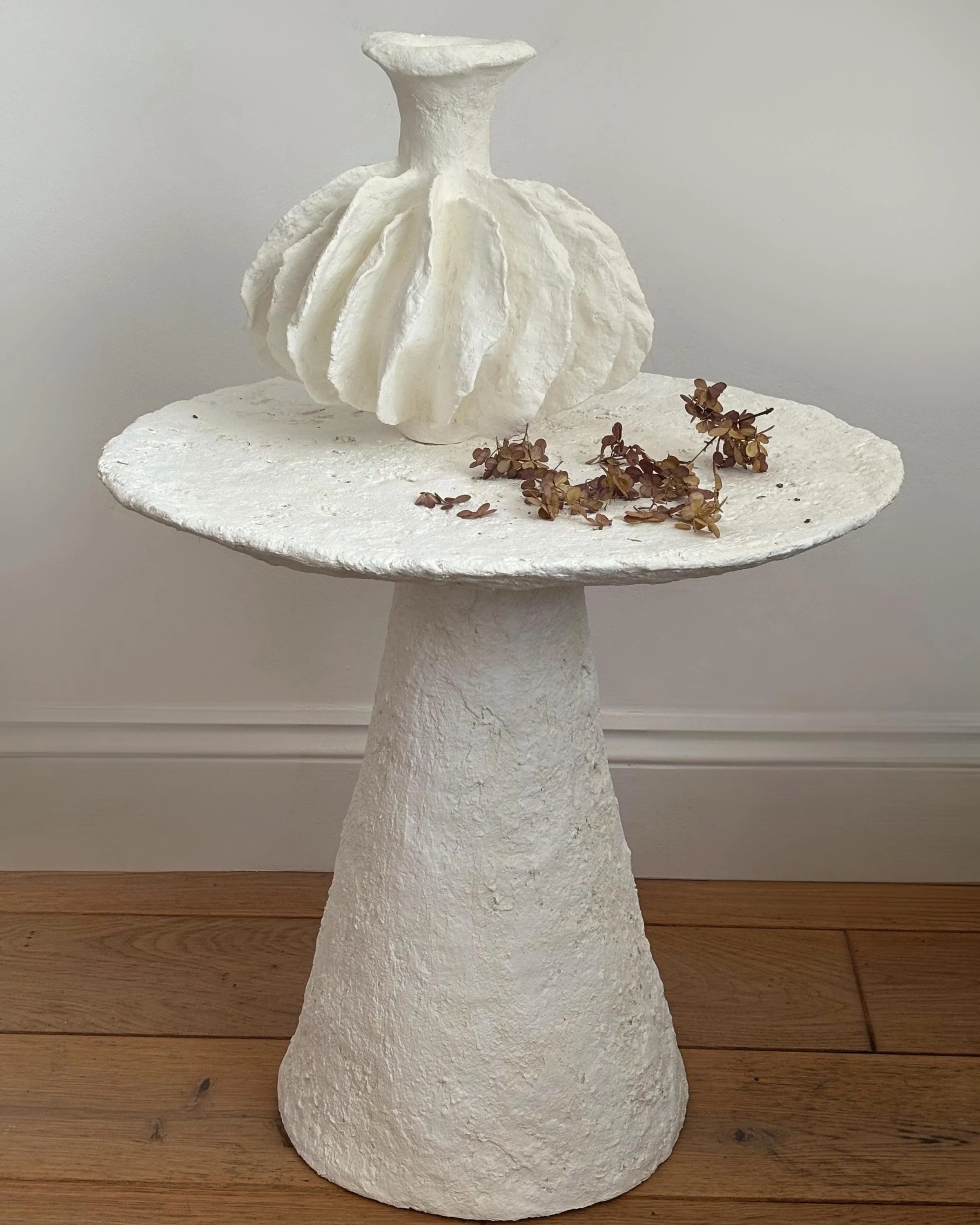 Side Table N.30, handmade white paper clay side table, disc top on a cone base, front view. Papier Atelier London