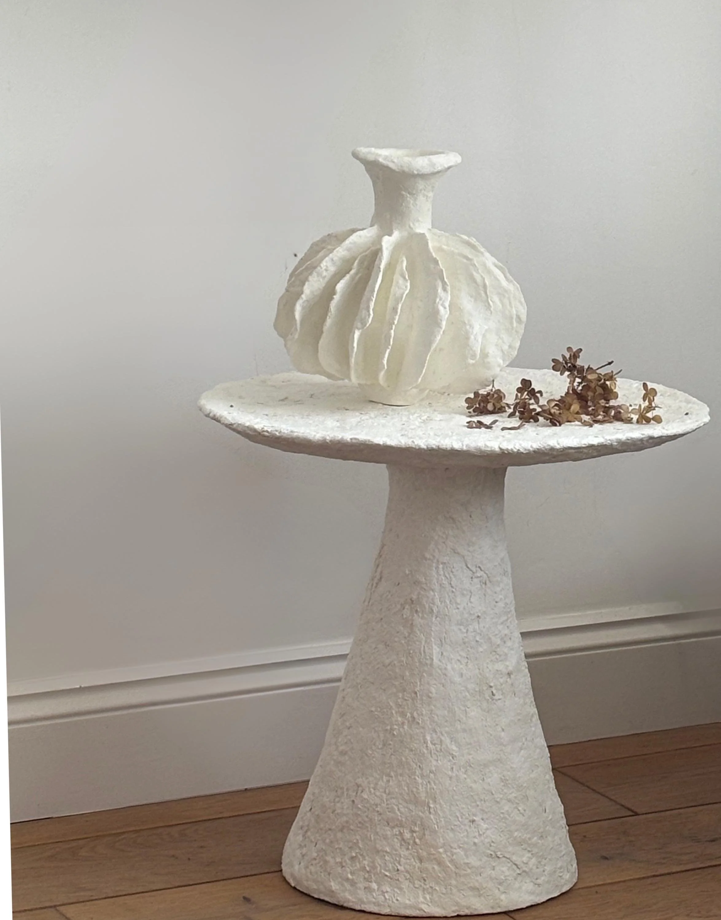 Side Table N.30, handmade white paper clay side table, disc top on a cone base, side view. Papier Atelier London