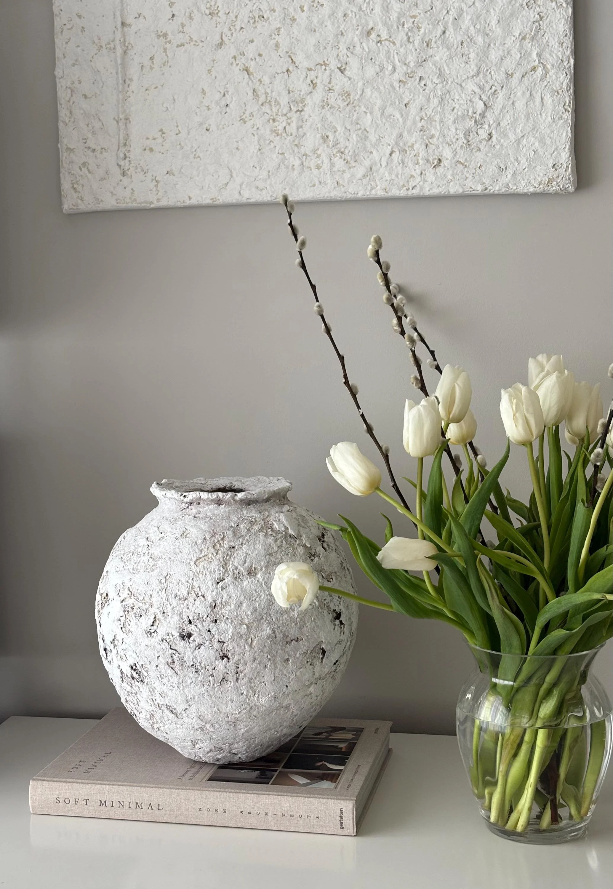 Oval Vessel N.26, handmade white paper clay vessel, aged textured surface, in a room setting. Papier Atelier London