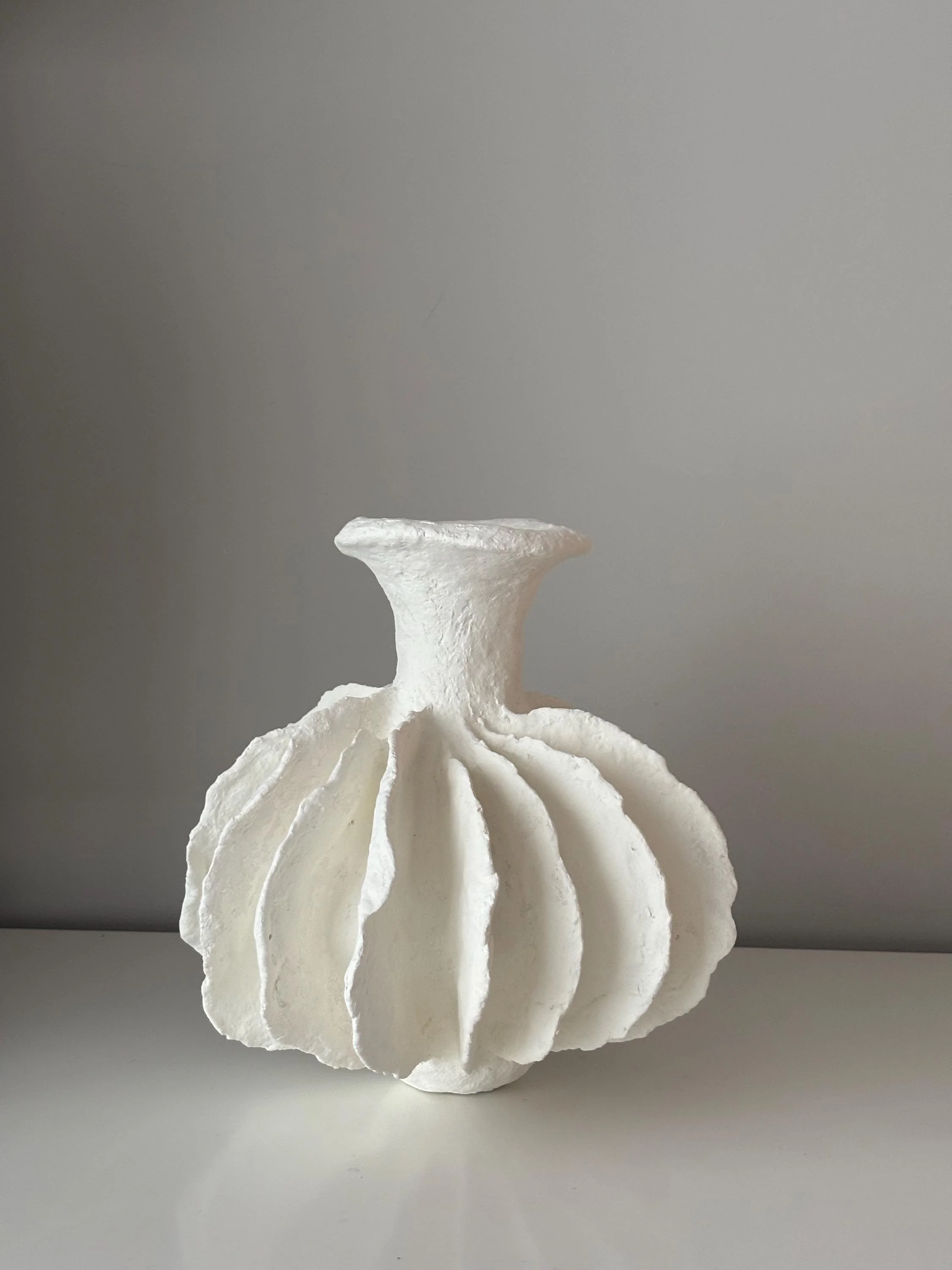 Pleated Vase N.28, handmade white pleated paper clay vase, folded form, another angle. Papier Atelier London