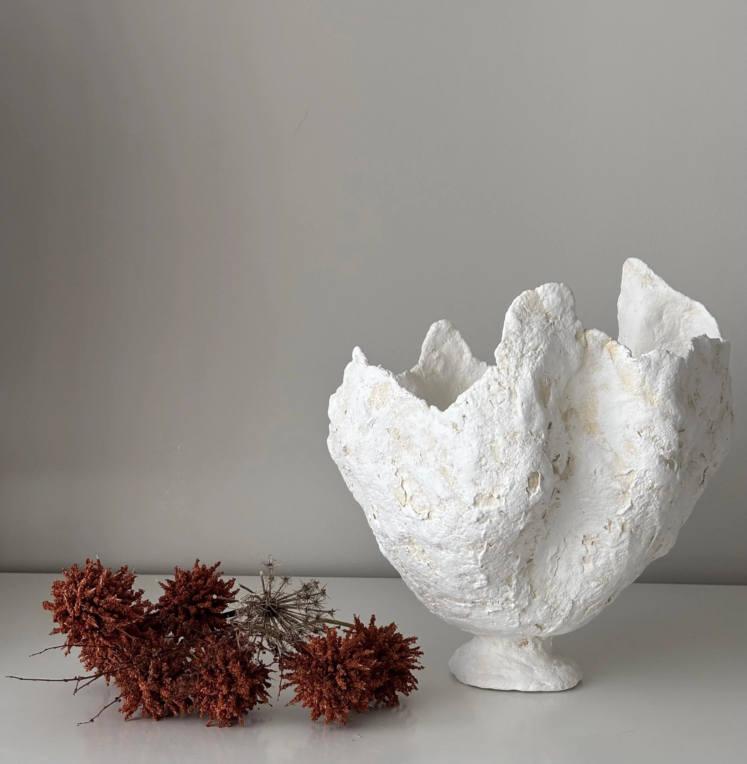 Petal Vase N.29, handmade white paper clay vase, wavy petal-like rim, front view. Papier Atelier London