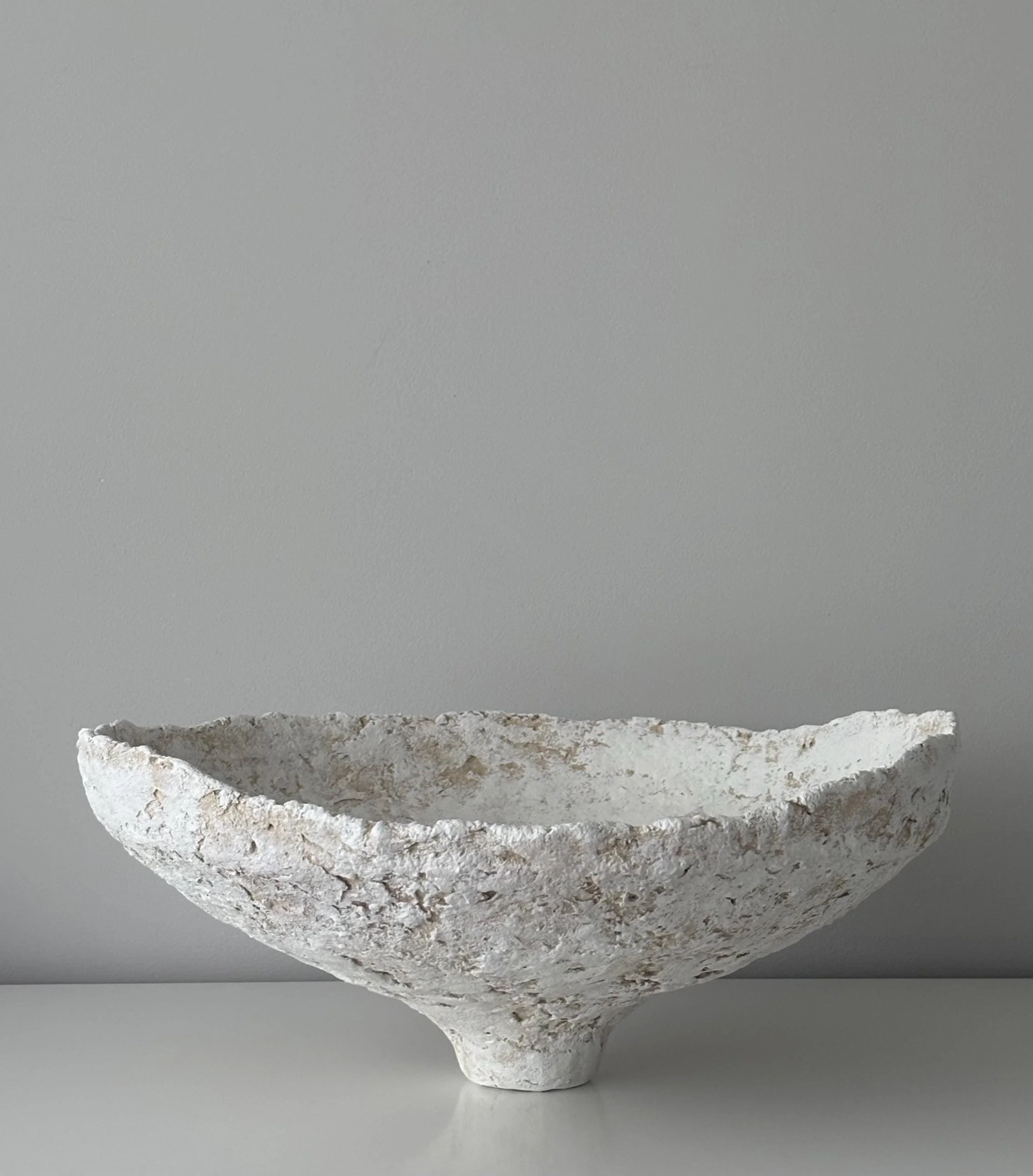 Wide Bowl N.32, handmade white paper clay bowl, on a narrow foot, another angle. Papier Atelier London