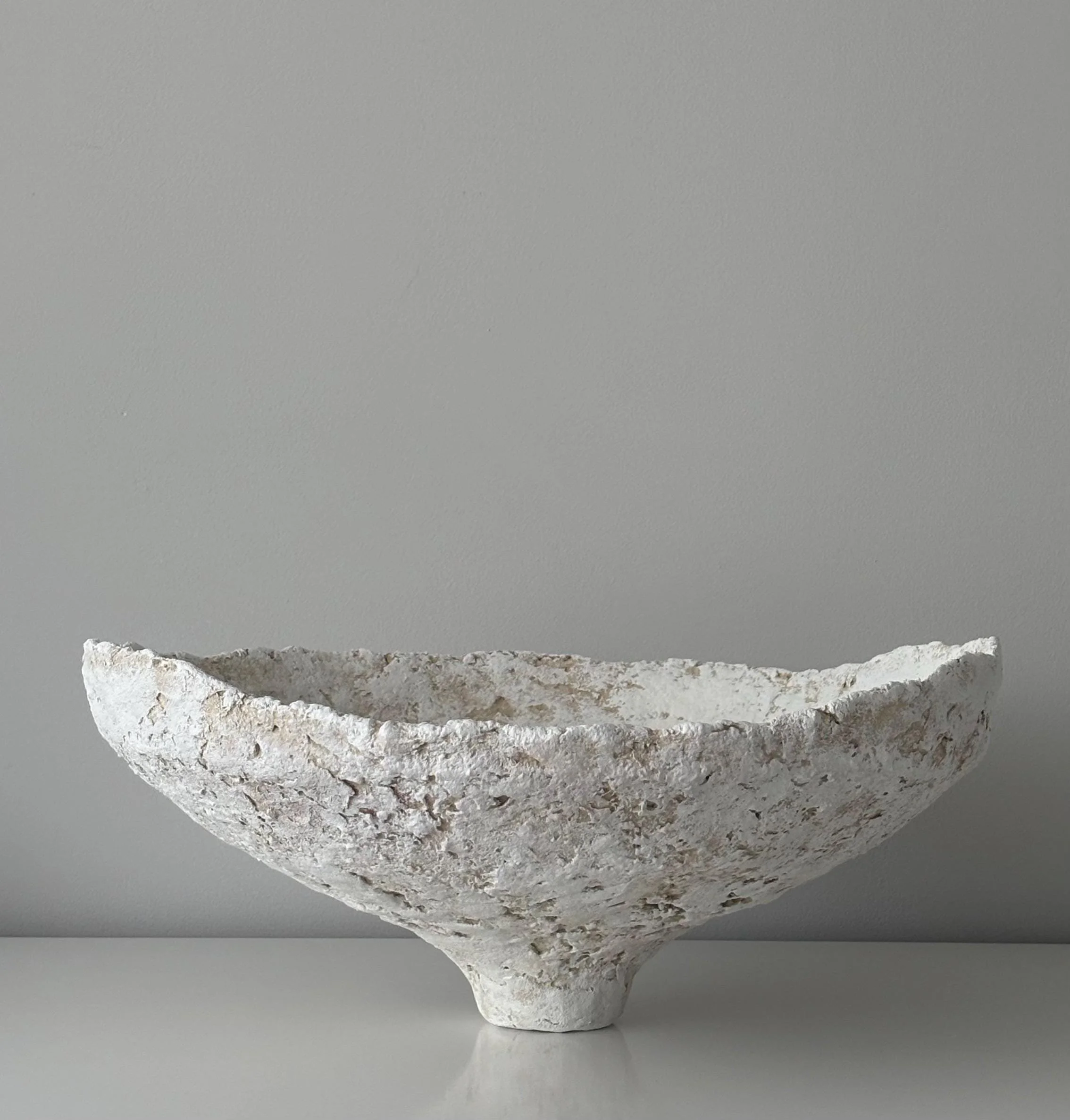 Wide Bowl N.32, handmade white paper clay bowl, on a narrow foot, side view. Papier Atelier London