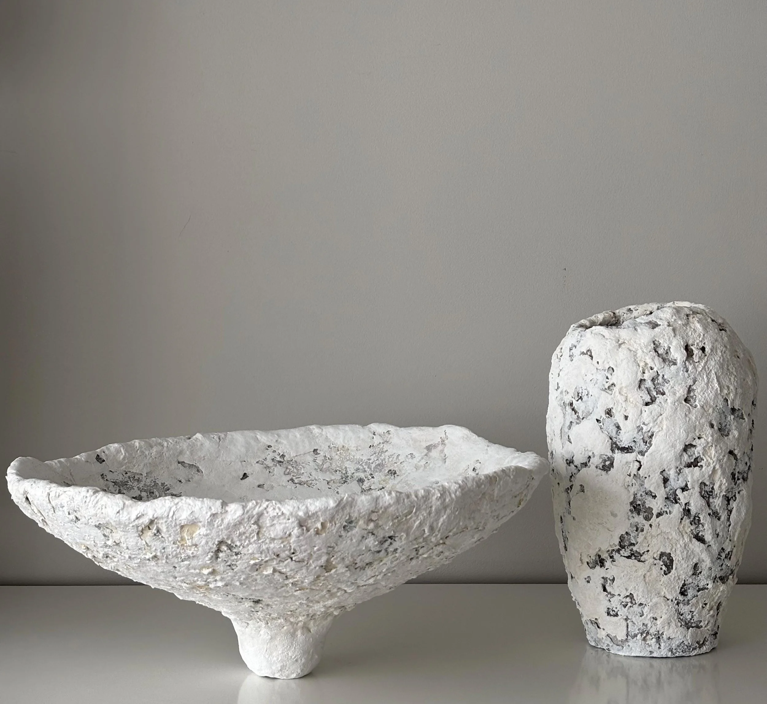 Large Bowl N.34, handmade large white paper clay bowl, on a slender foot, in a room setting. Papier Atelier London