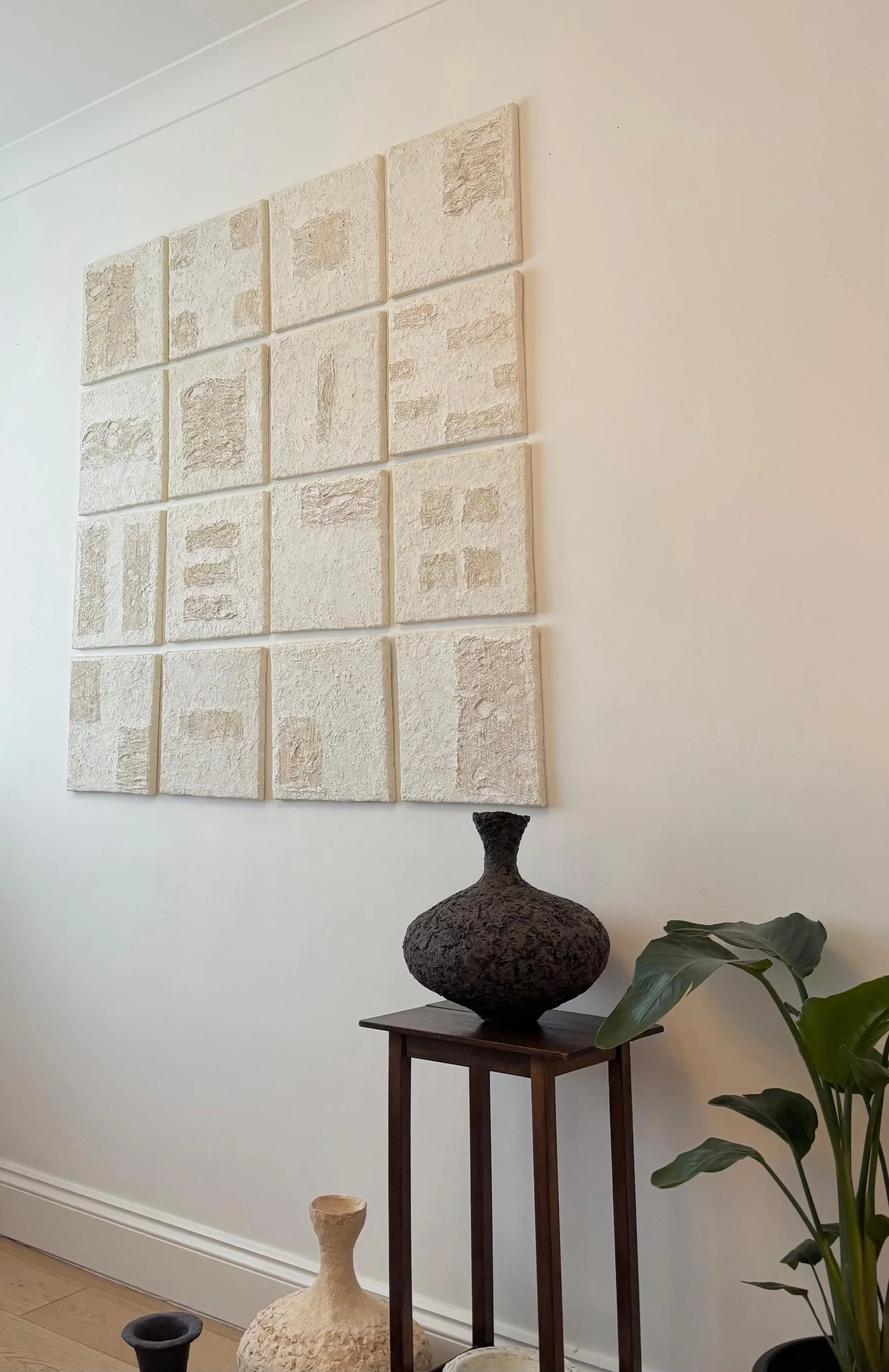 Wall Set N.35, handmade set of sixteen paper clay wall pieces, textured canvases, another angle. Papier Atelier London