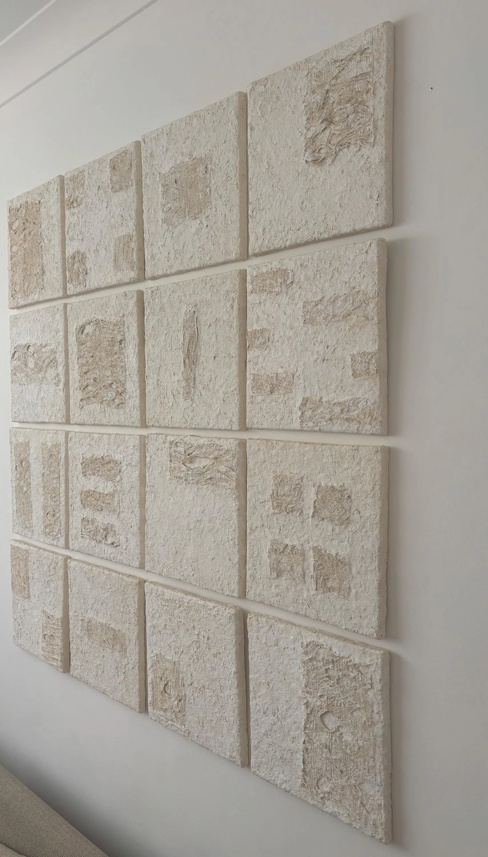Wall Set N.35, handmade set of sixteen paper clay wall pieces, textured canvases, side view. Papier Atelier London
