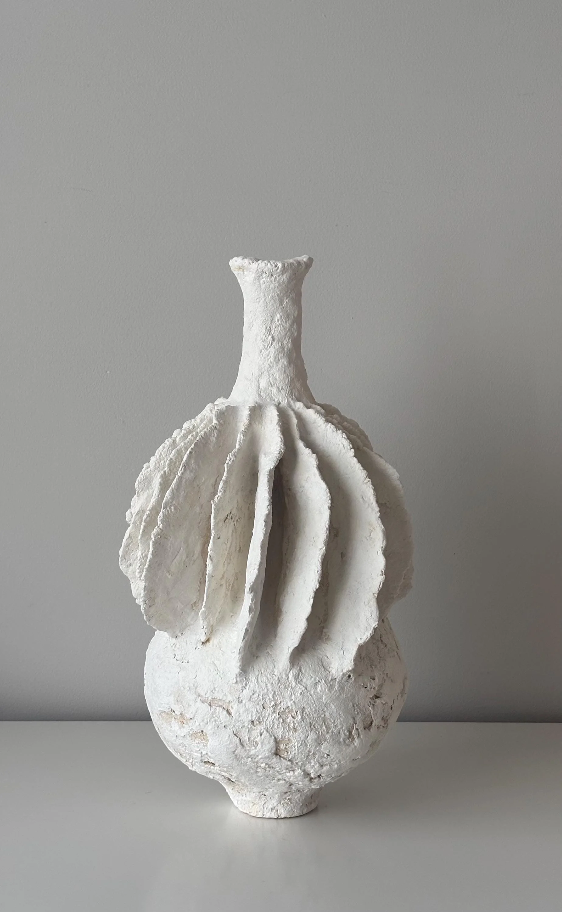 Pleated Vase N.40, handmade tall white pleated paper clay vase, folded fins, another angle. Papier Atelier London