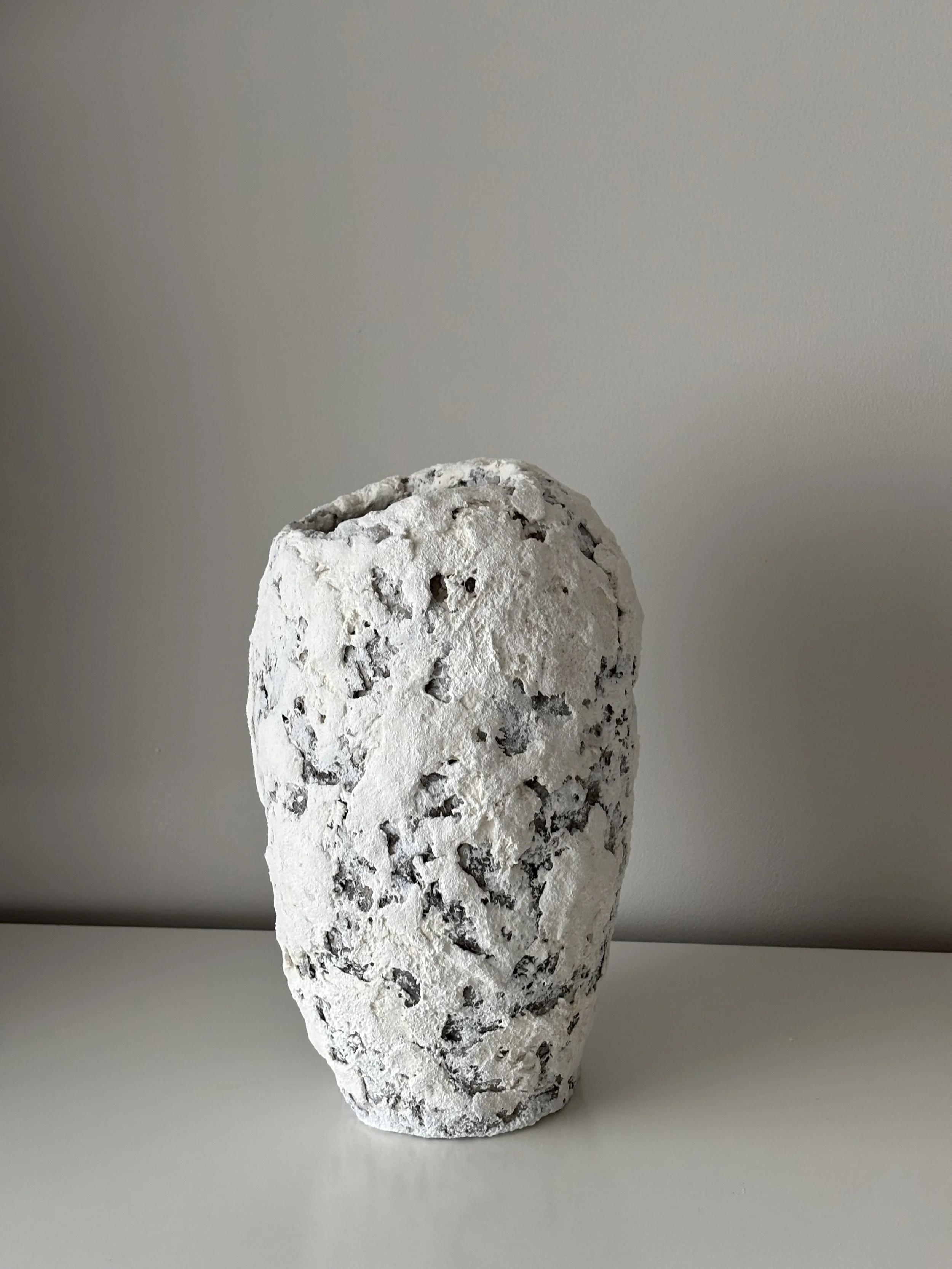Side profile of Textured White Vase N.41 in Wabi-Sabi inspired paper clay, showing the sculptural silhouette and textured surface, London atelier