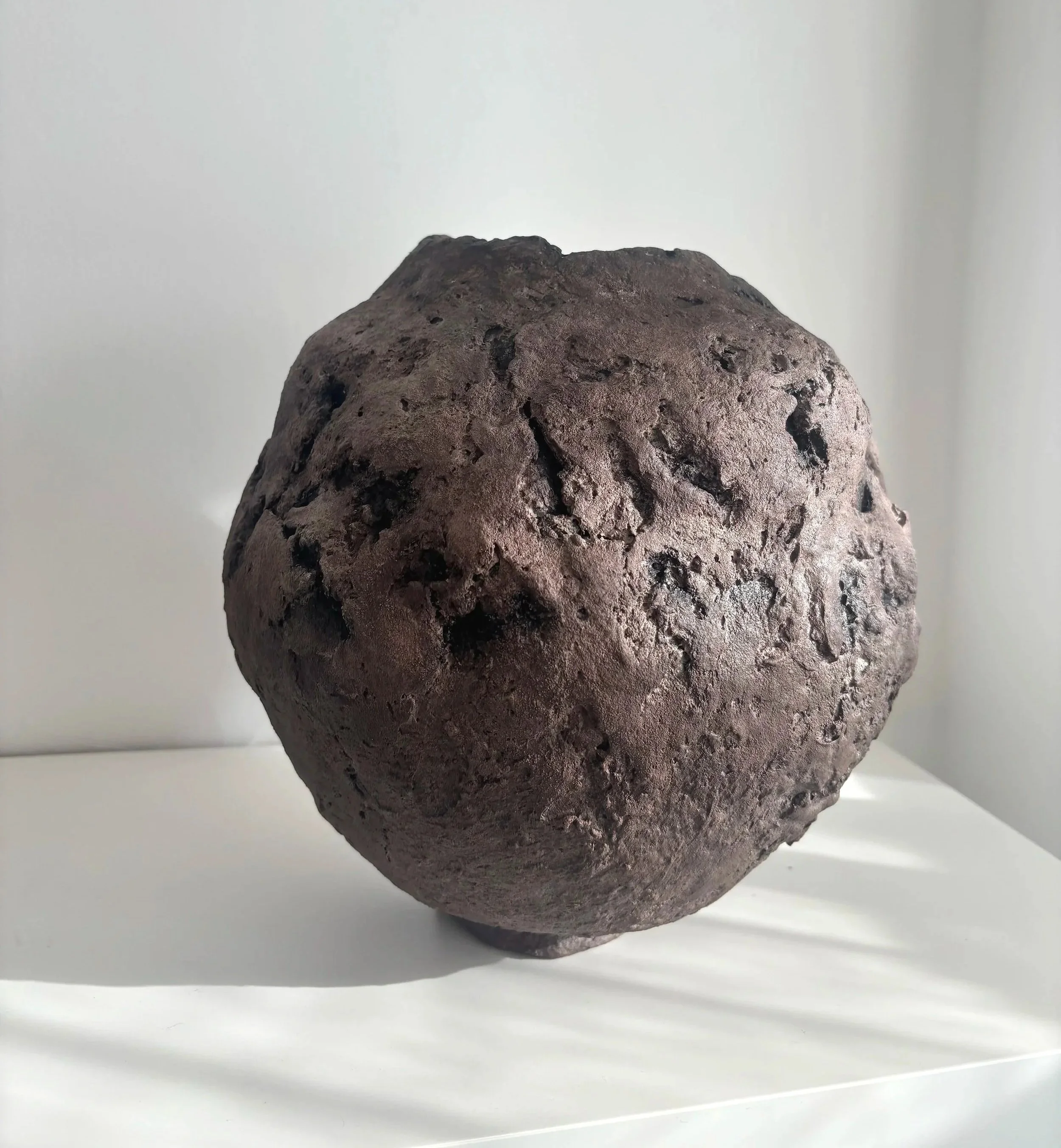 A tall, substantial form with an organic textured surface. The vessel evolved through an intuitive making process—each irregular mark and natural variation an honest expression of the material. Intended for decorative use. Works well as a standalone