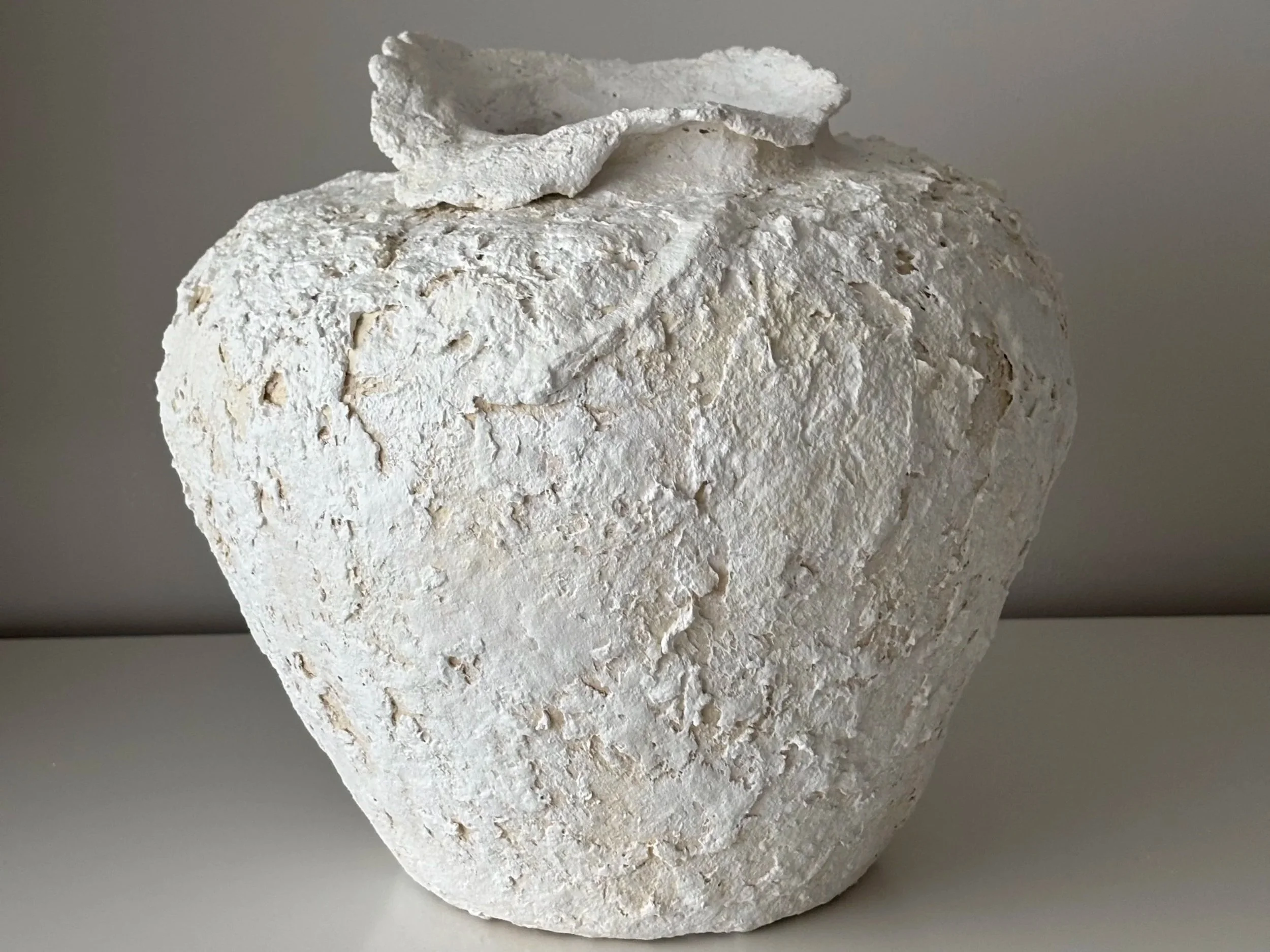 Wabi Sabi Neutral Tones Vessel N.2, neutral tones paper clay vessel viewed from an alternate angle highlighting asymmetrical shape, from Papier Atelier London