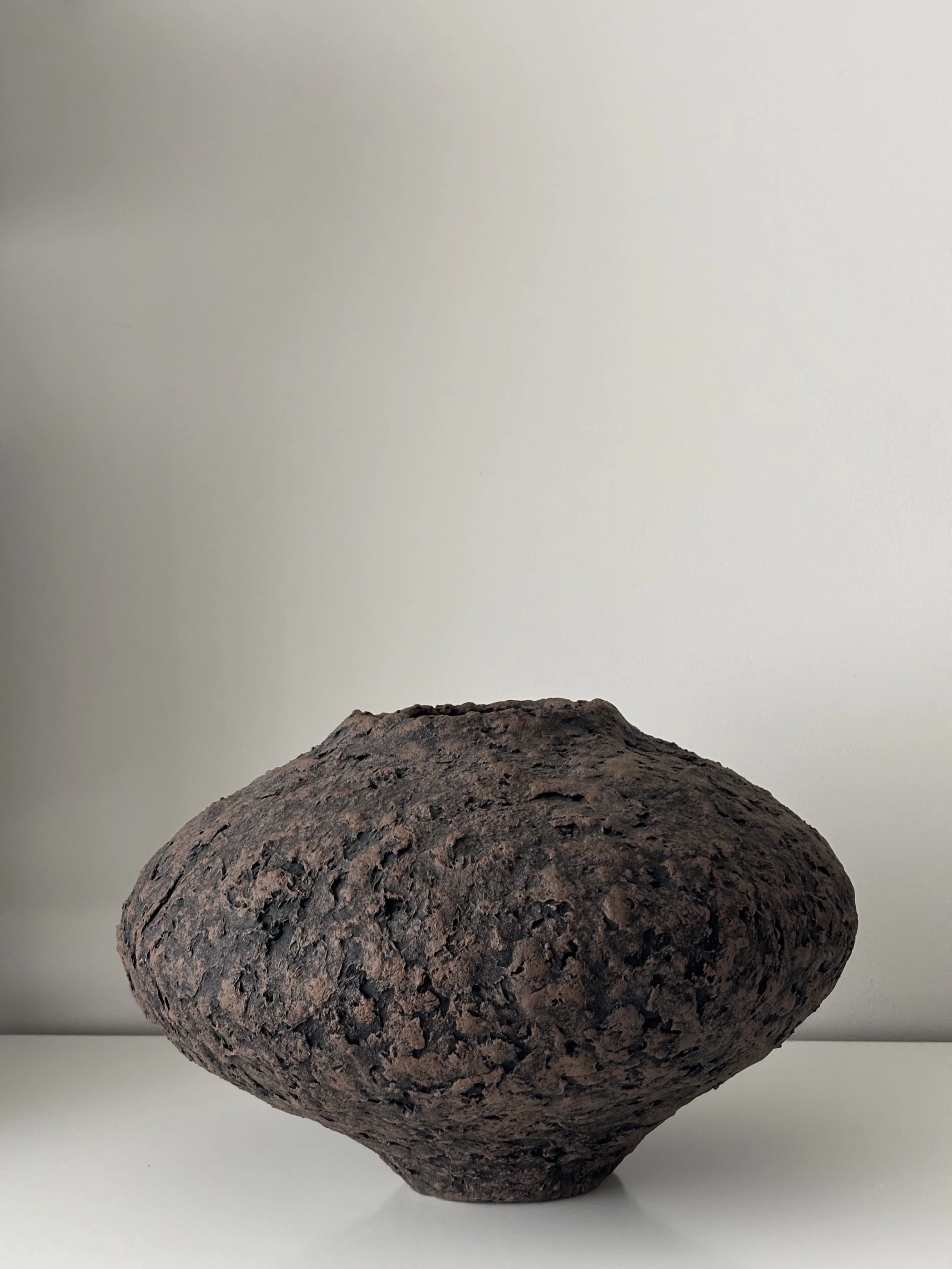 Rear view of Wabi Sabi Vase N.44 in off-white textured paper clay, showing organic asymmetry from behind, minimalist sculptural home decor