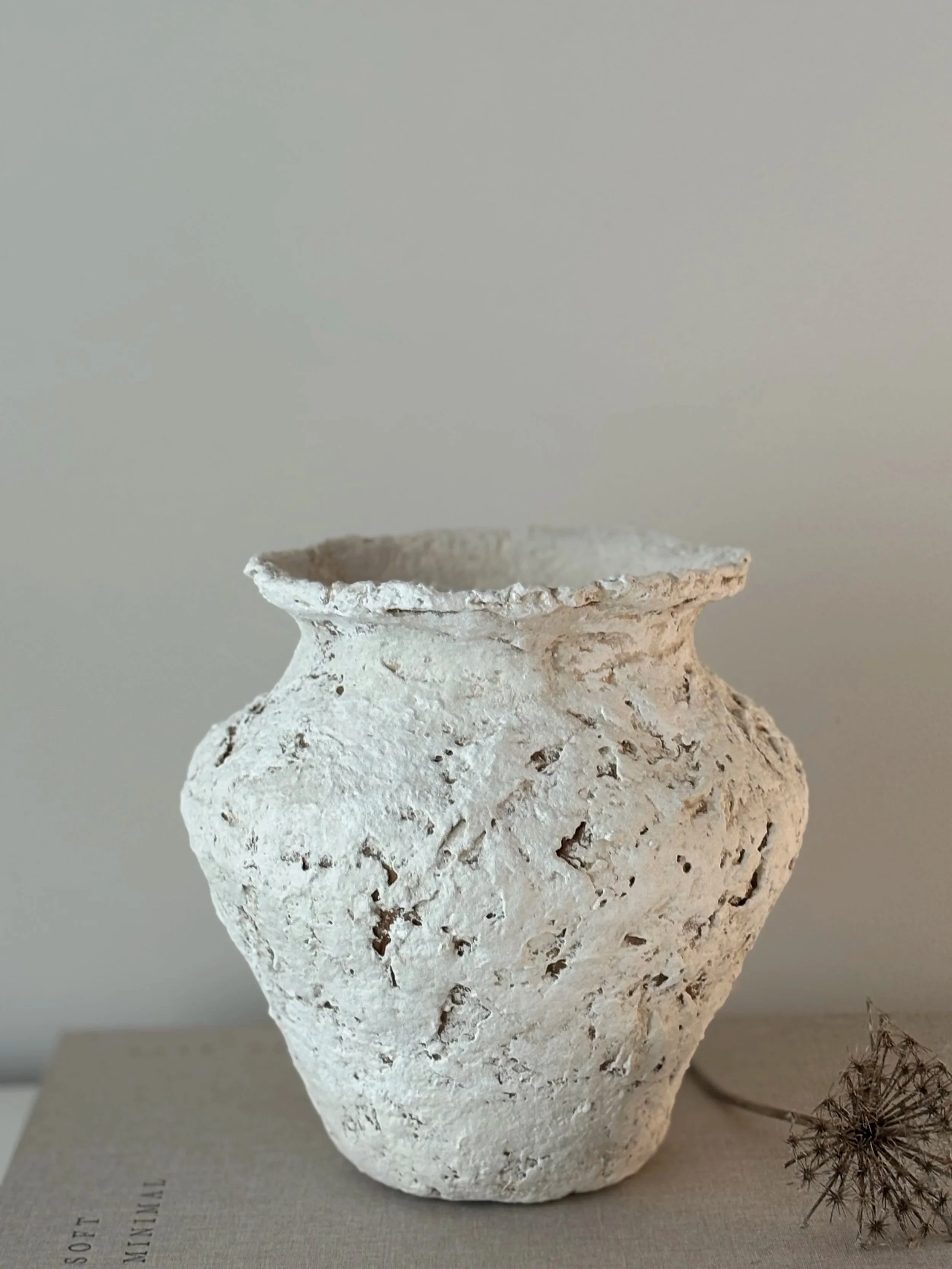 Three-quarter view of Sculptural Vase N.61, off-white textured paper clay vase with organic irregular form, minimalist sculptural home decor