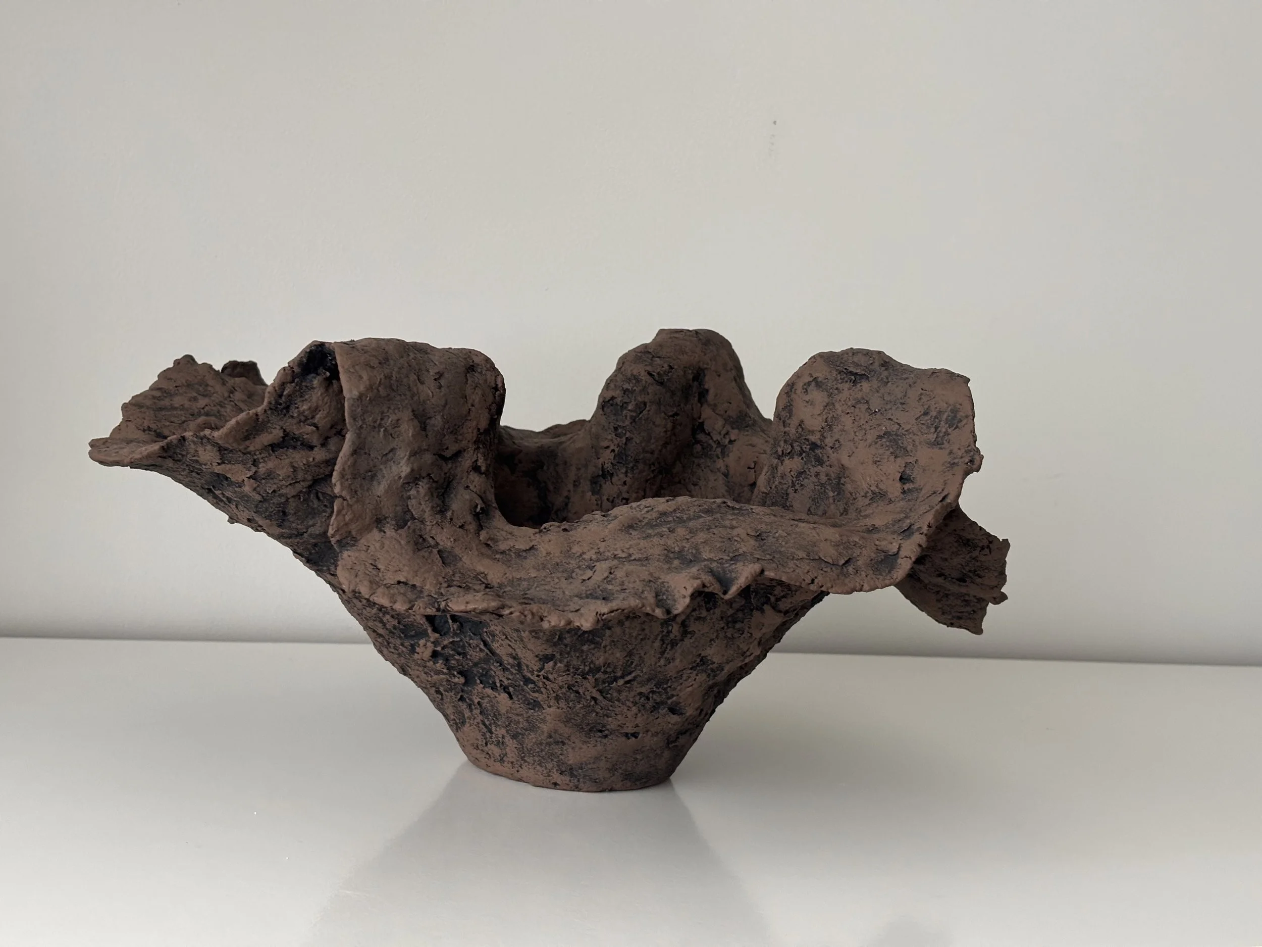 Handkerchief Bowl N.51 from an angled perspective, dark brown & off-white sculptural paper clay bowl with irregular organic edges, unique handcrafted pottery