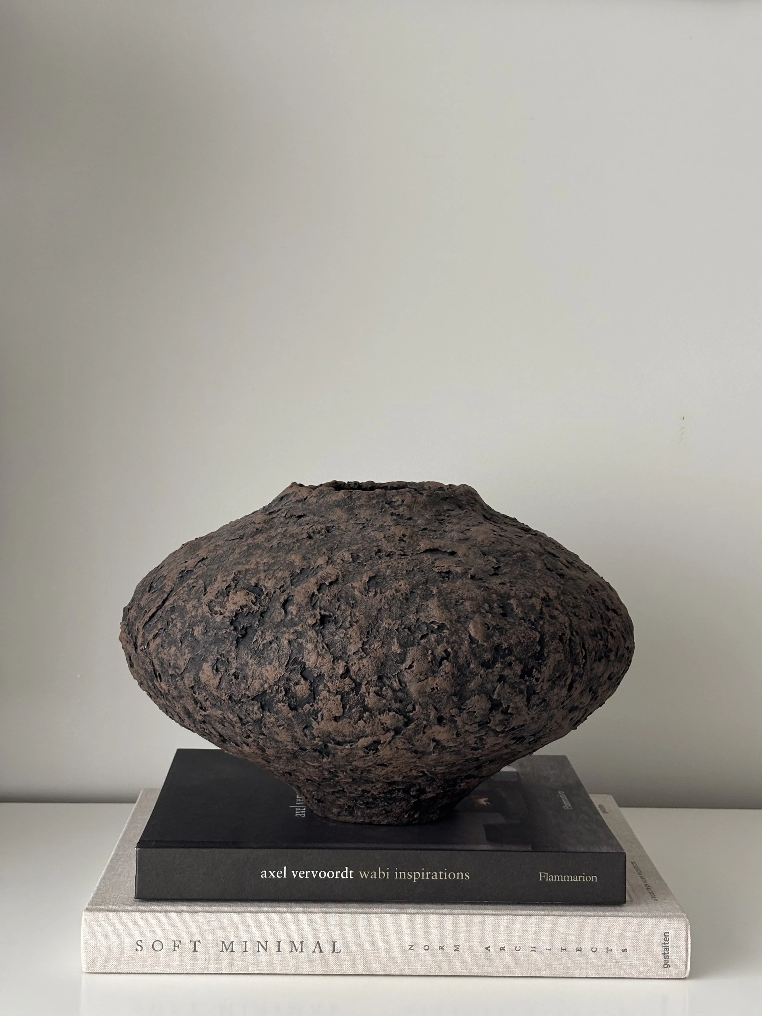 Wabi Sabi Vase N.44 from an angled perspective, off-white sculptural paper clay vase with irregular organic edges, unique handcrafted pottery