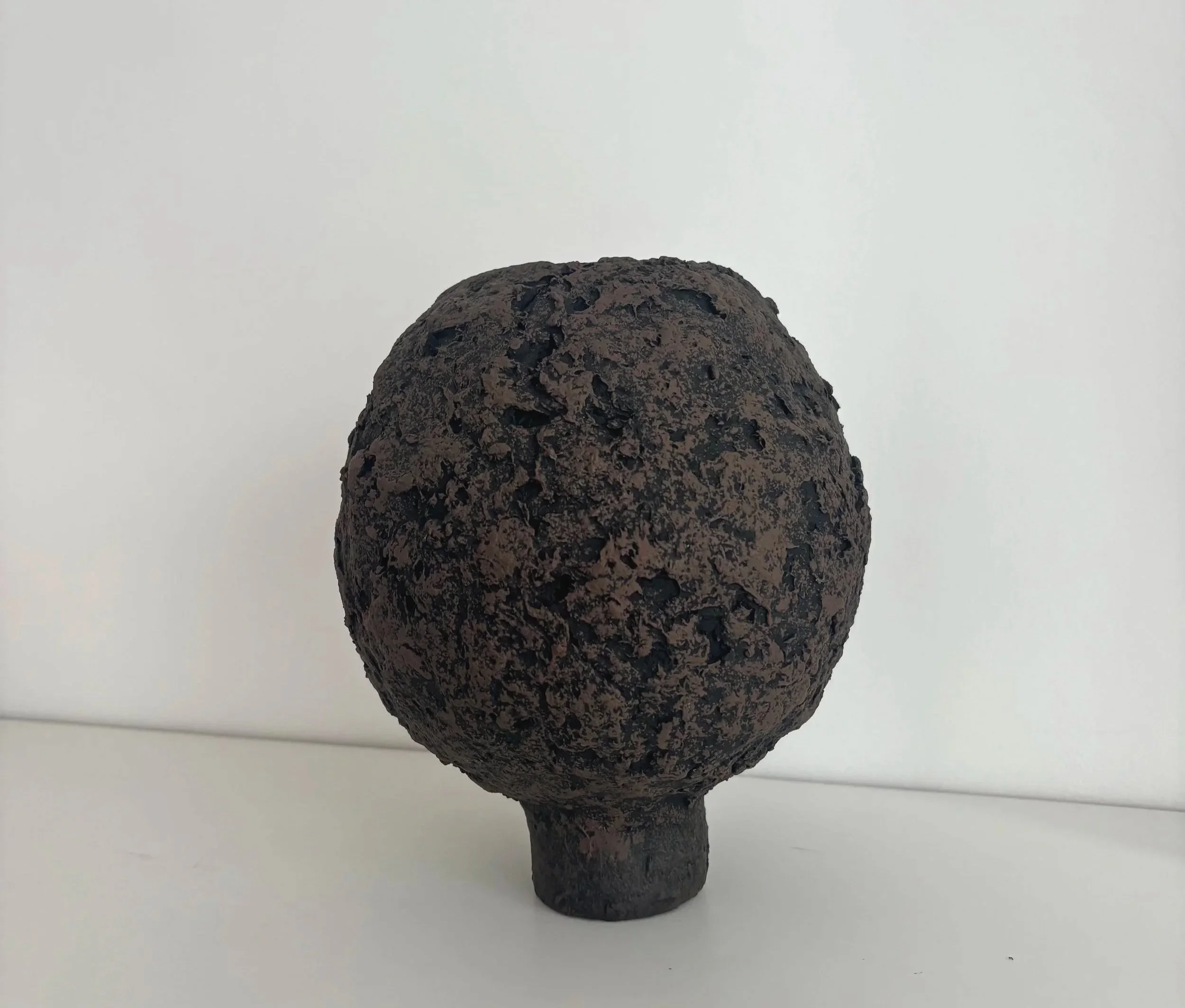 Dark Brown Organic Vase N.55, dark brown paper clay vase viewed from an alternate angle highlighting asymmetrical shape, from Papier Atelier London