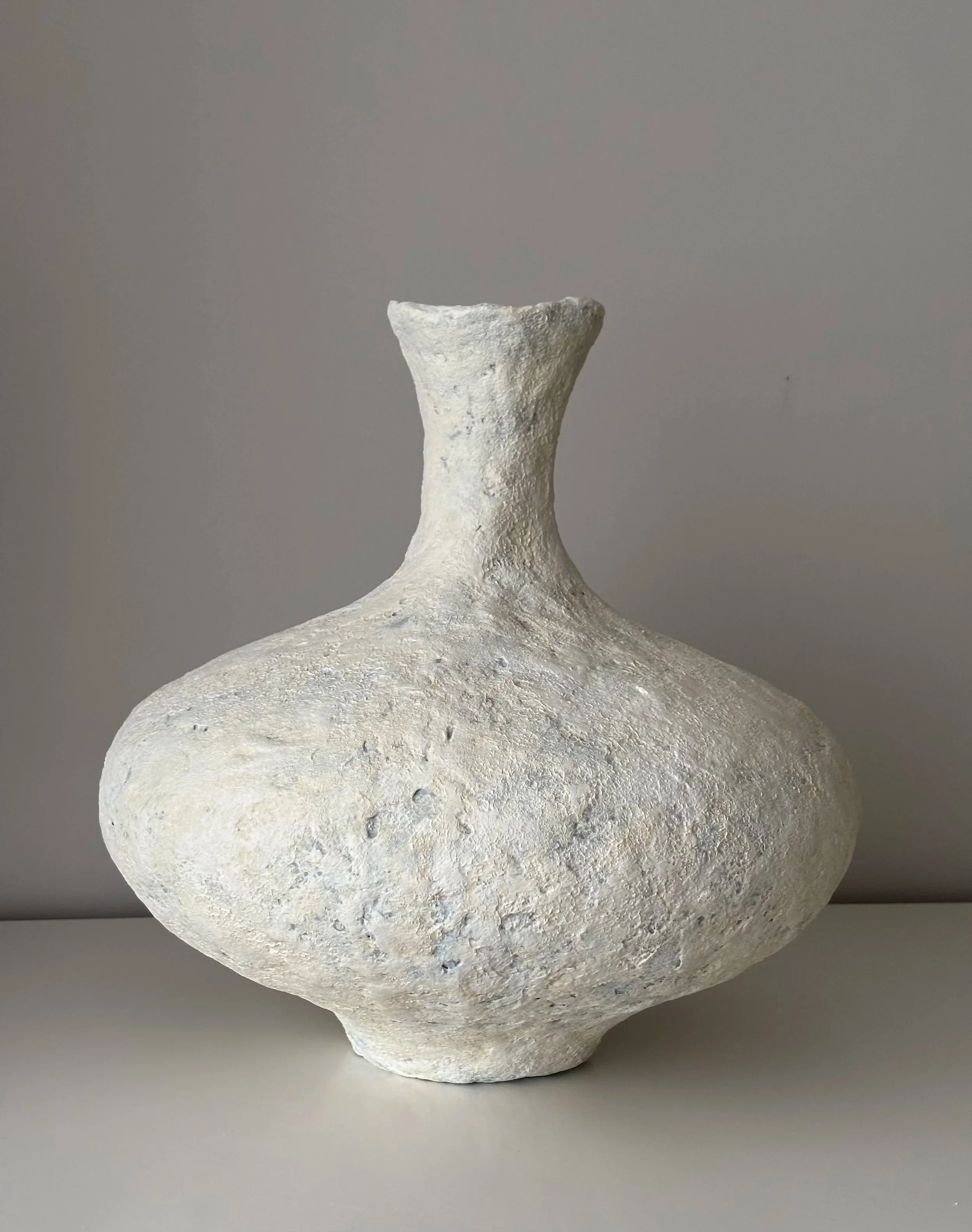 Contemporary Neutral Tones Vessel N.16, neutral tones paper clay vessel viewed from an alternate angle highlighting asymmetrical shape