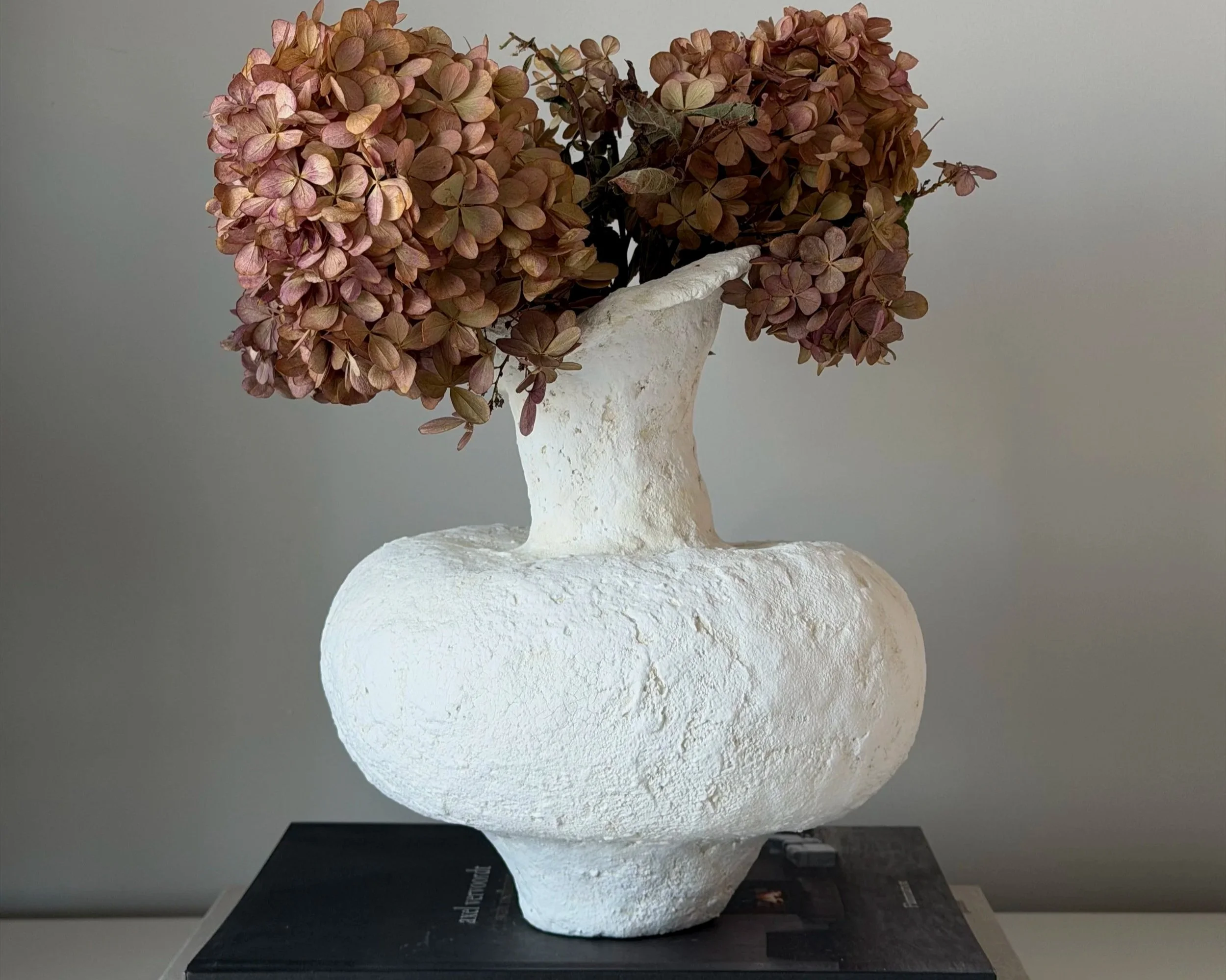 Asymmetric Vessel N.48 — With Dried Botanicals White paper clay vessel styled with dried hydrangeas, handmade by Papier Atelier London