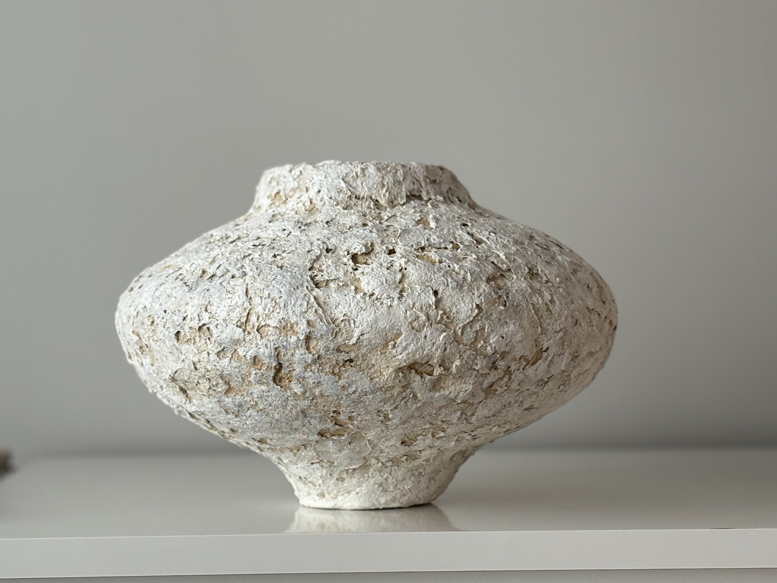 Side profile of Contemporary Textured Vessel N.75 in Wabi-Sabi inspired paper clay, showing the sculptural silhouette and textured surface, London atelier
