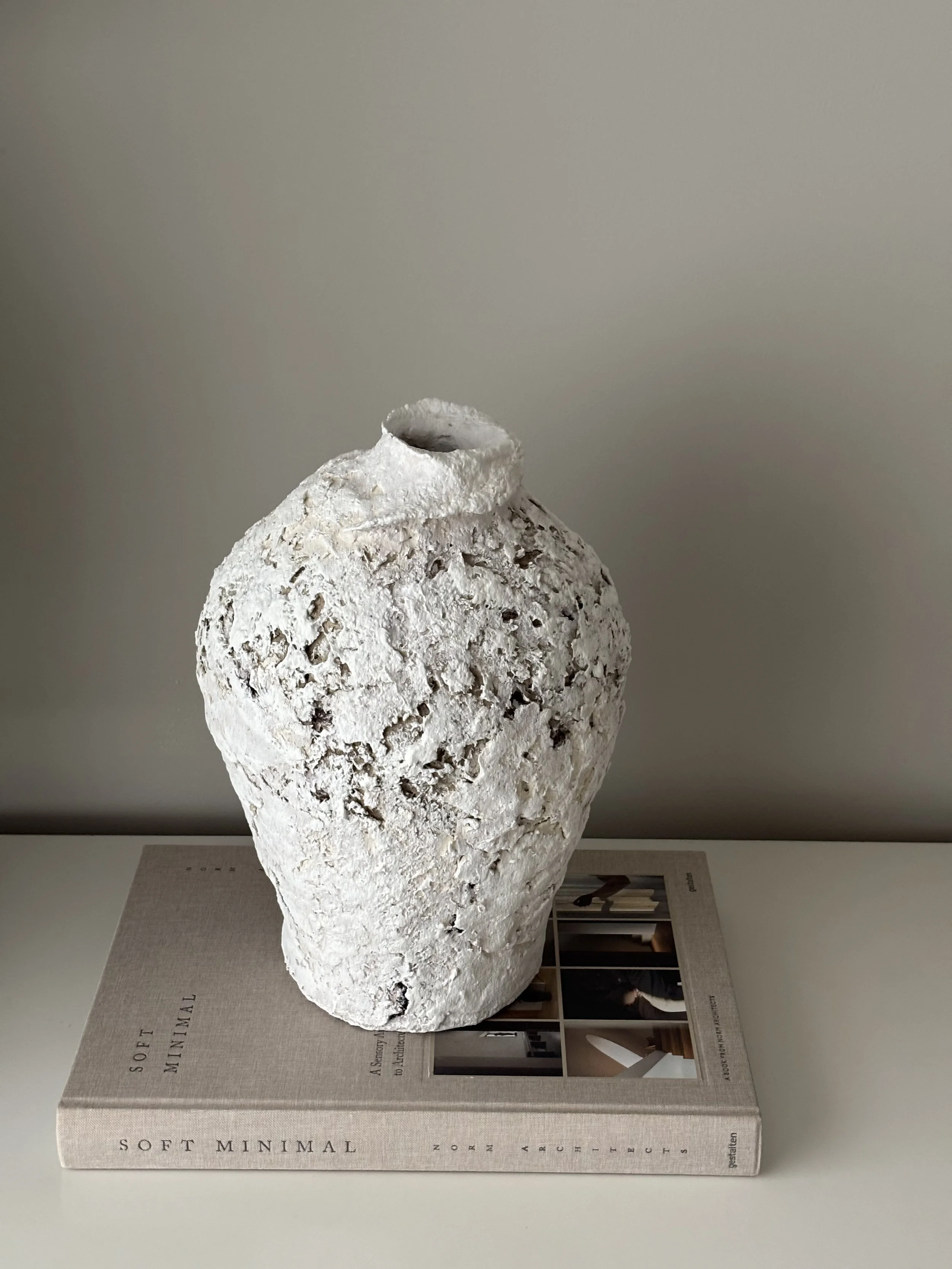 Rear view of Textured Vessel N.22 in off-white paper clay, showing organic asymmetry from behind, from Papier Atelier London
