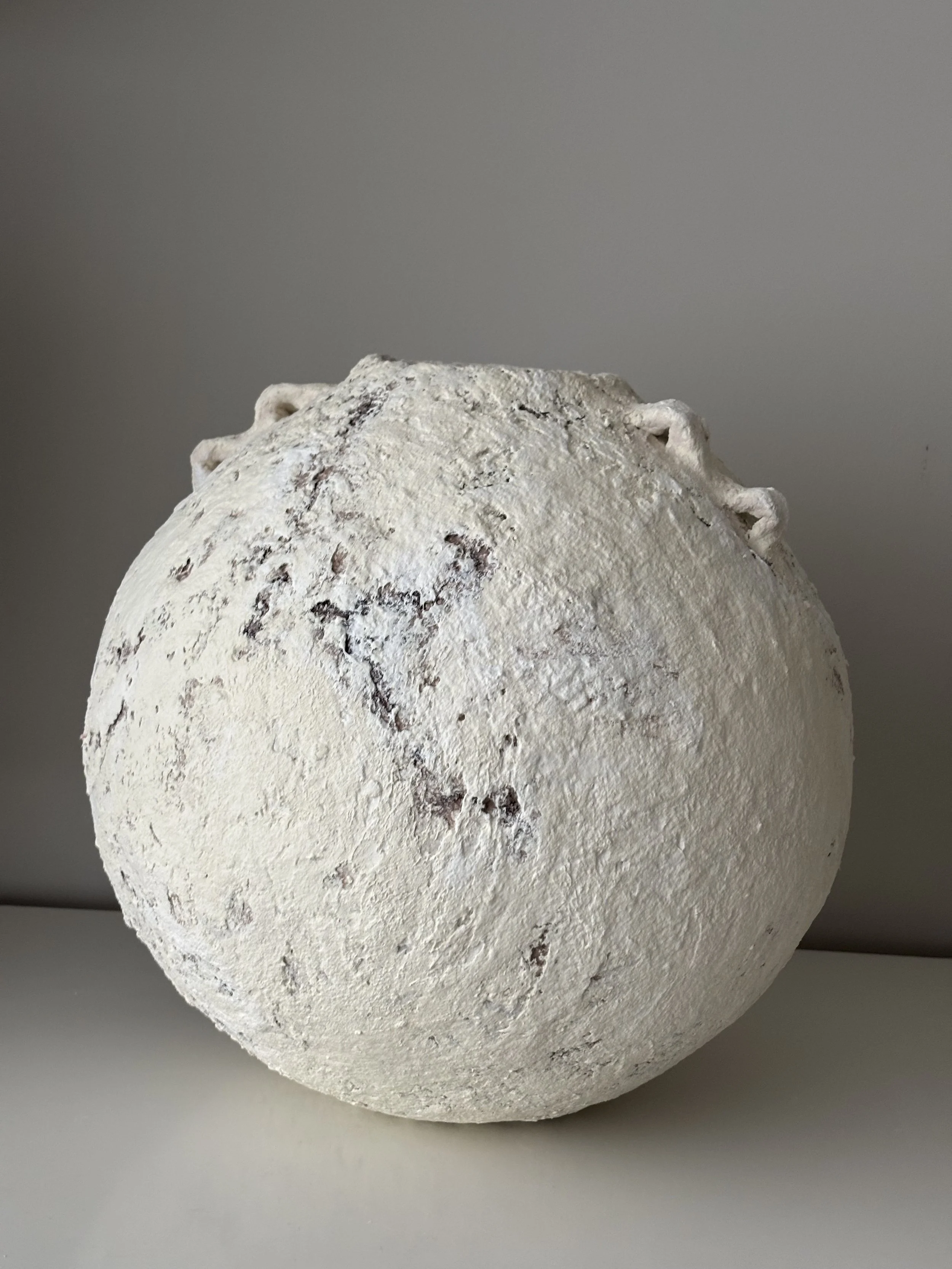 Three-quarter view of Extra Large Layered Vessel N.15, off-white textured paper clay vessel with organic irregular form, minimalist sculptural home decor