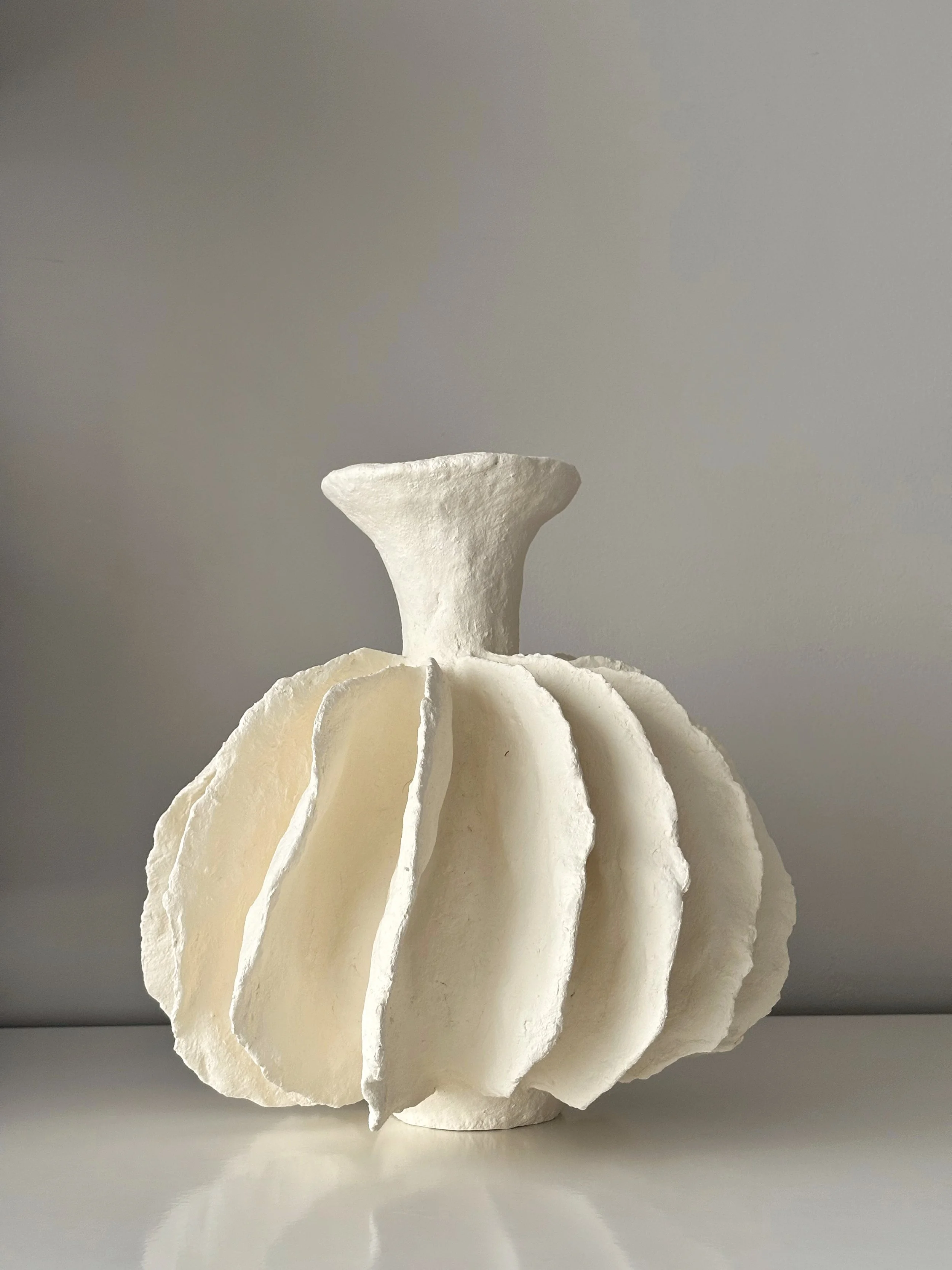 Close-up detail of Pleated Sculptural Vase N.10 surface texture, showing sculptural paper clay imperfections and Wabi-Sabi character, unique handcrafted pottery