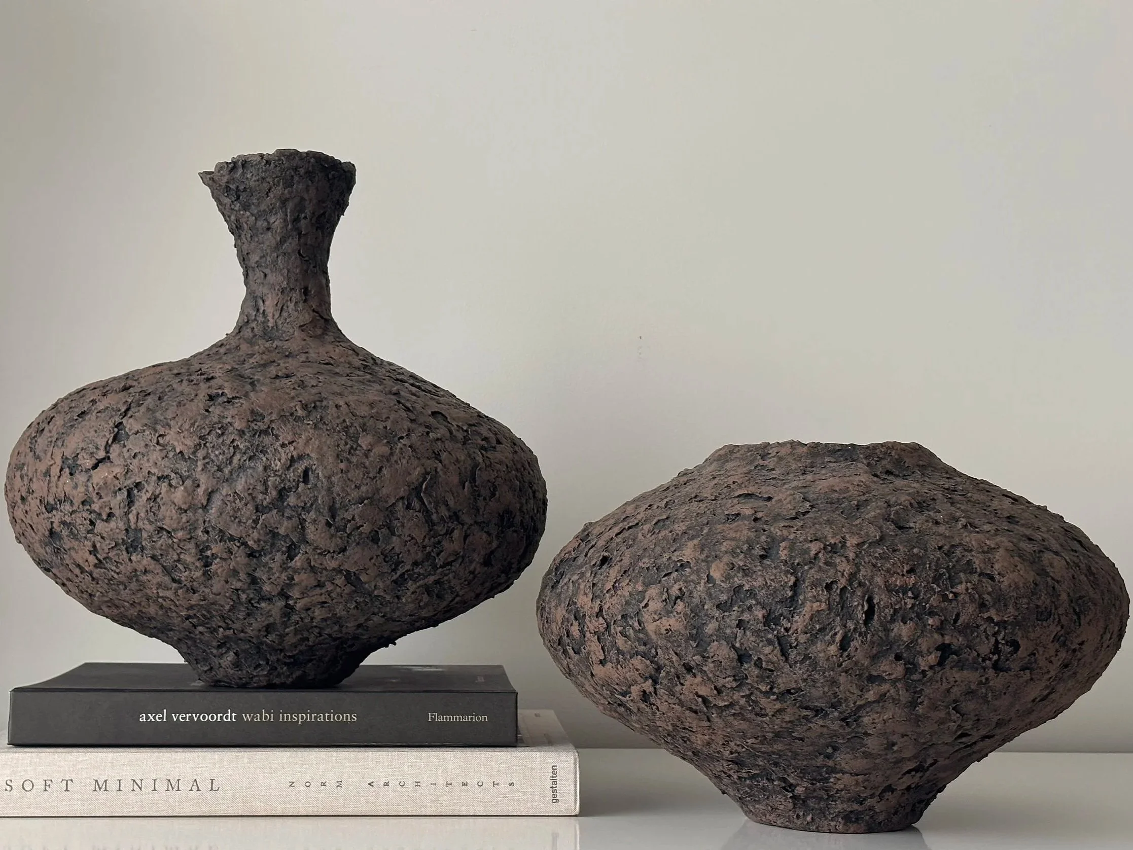 Tall Textured Vessel N.1, off-white paper clay vessel viewed from an alternate angle highlighting asymmetrical shape, from Papier Atelier London