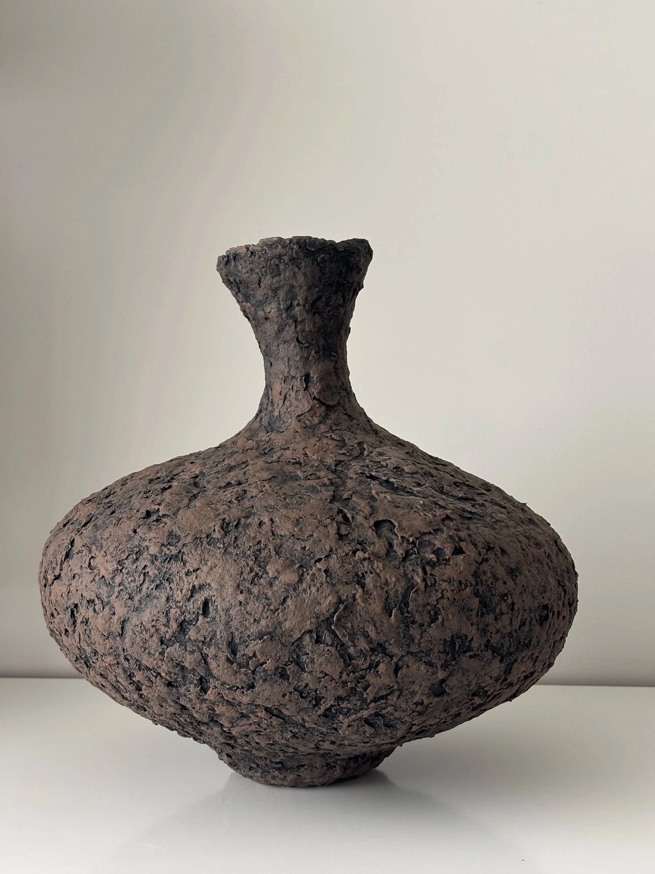 Side profile of Tall Textured Vessel N.1 in Wabi-Sabi inspired paper clay, showing the sculptural silhouette and textured surface, London atelier