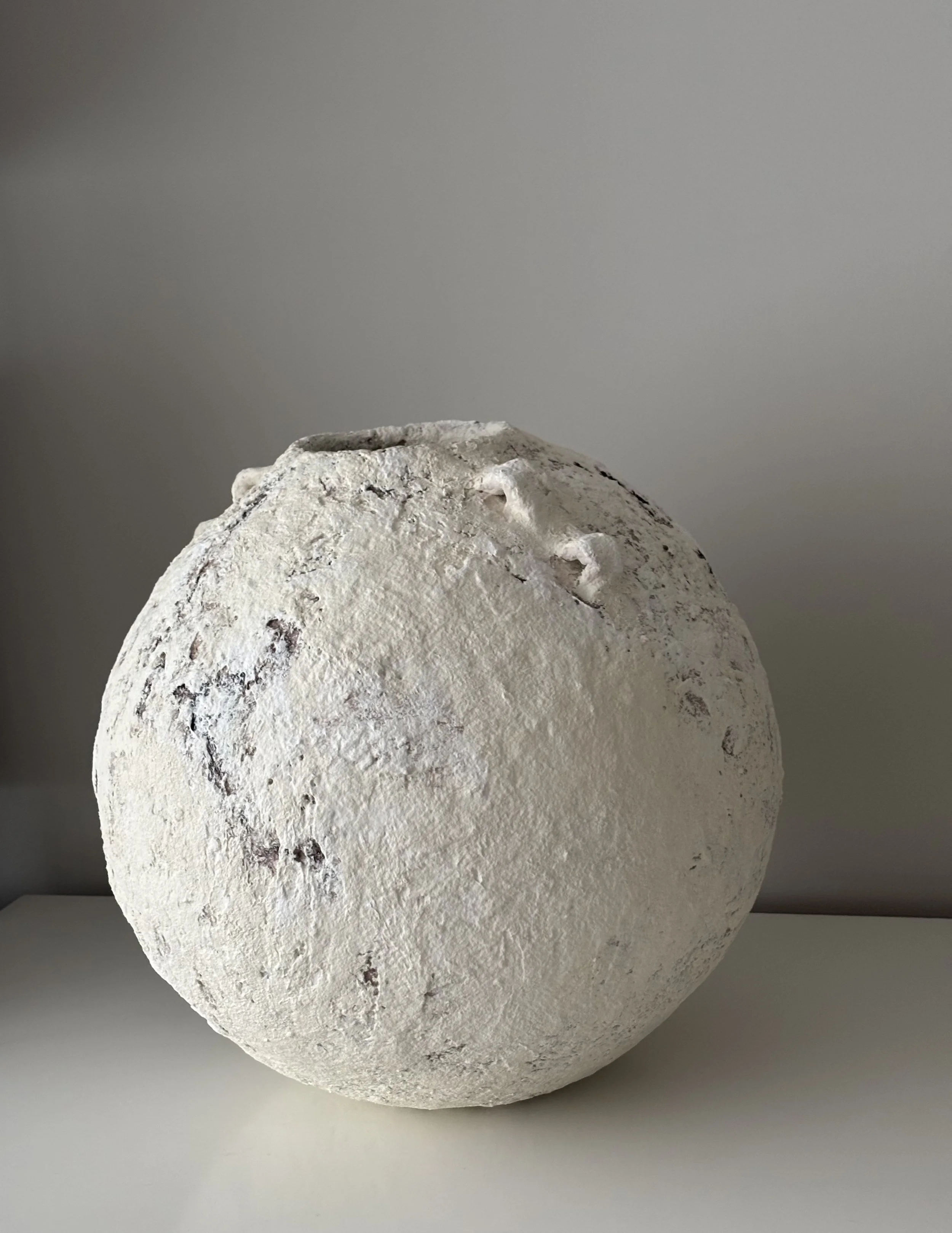 Rear view of Extra Large Layered Vessel N.15 in off-white paper clay, showing organic asymmetry from behind, from Papier Atelier London