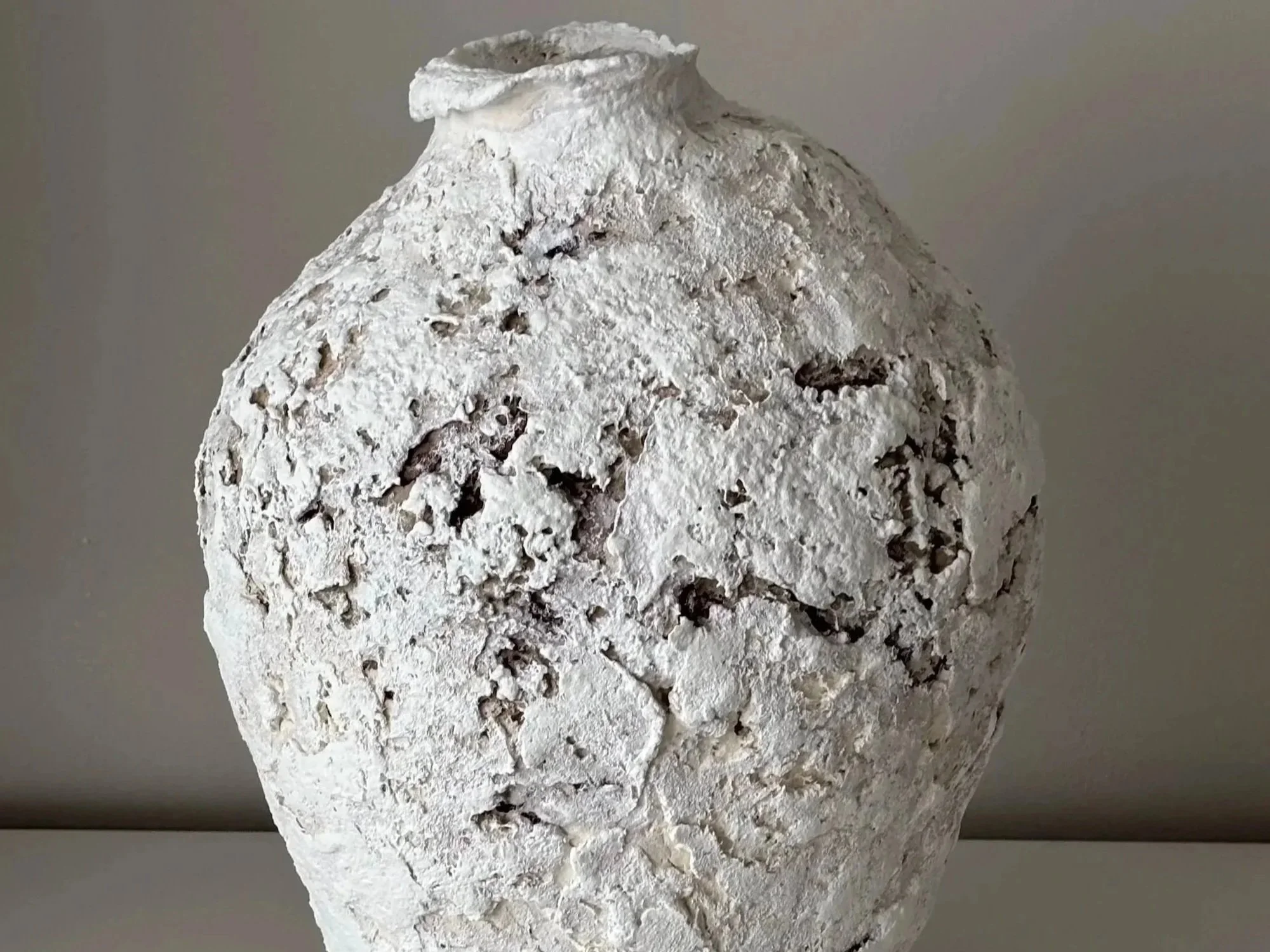 Side profile of Textured Vessel N.22 in Wabi-Sabi inspired paper clay, showing the sculptural silhouette and textured surface, London atelier