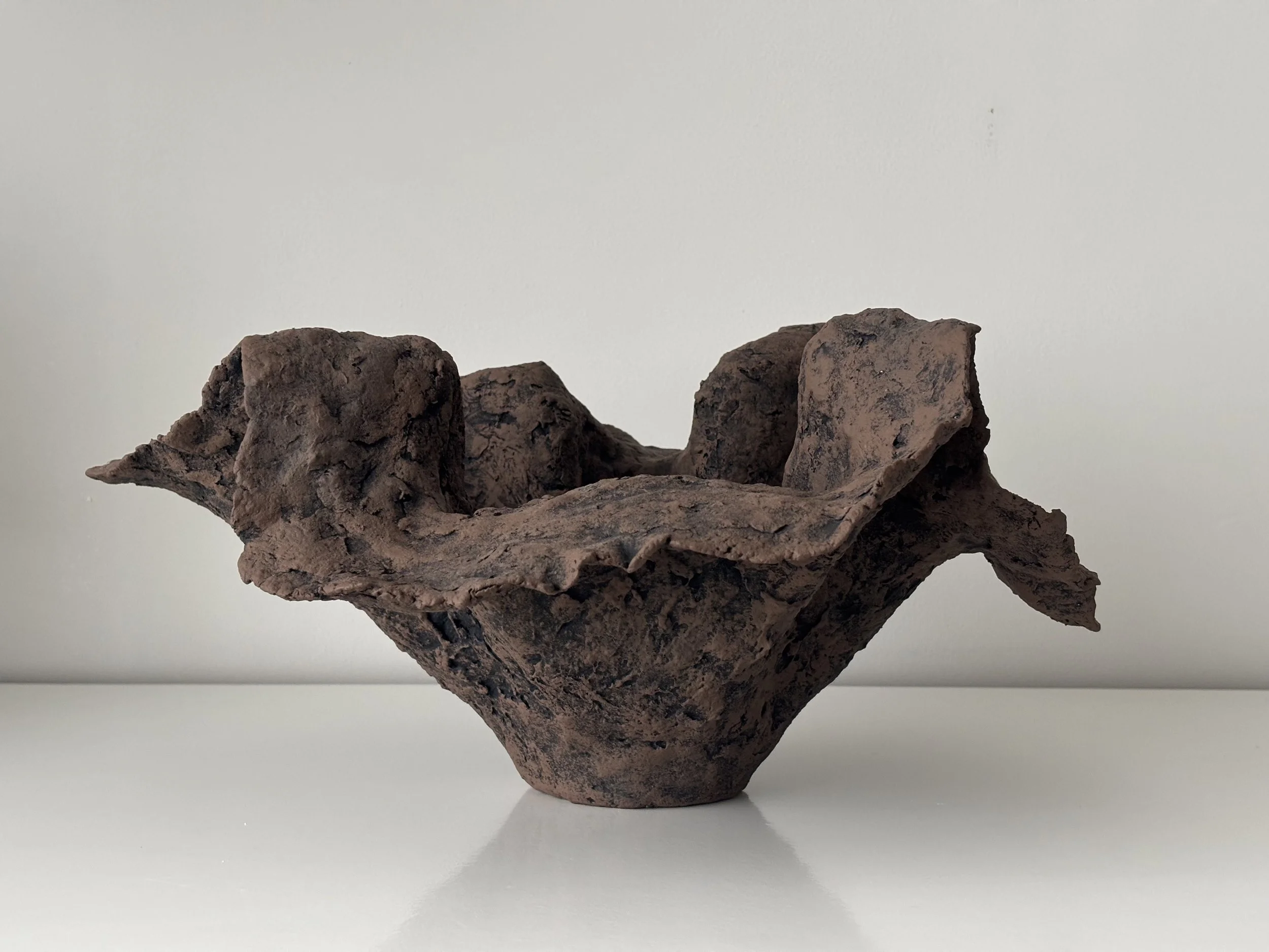 Handkerchief Bowl N.51 displayed in a styled setting, dark brown & off-white textured paper clay bowl as minimalist sculptural home decor