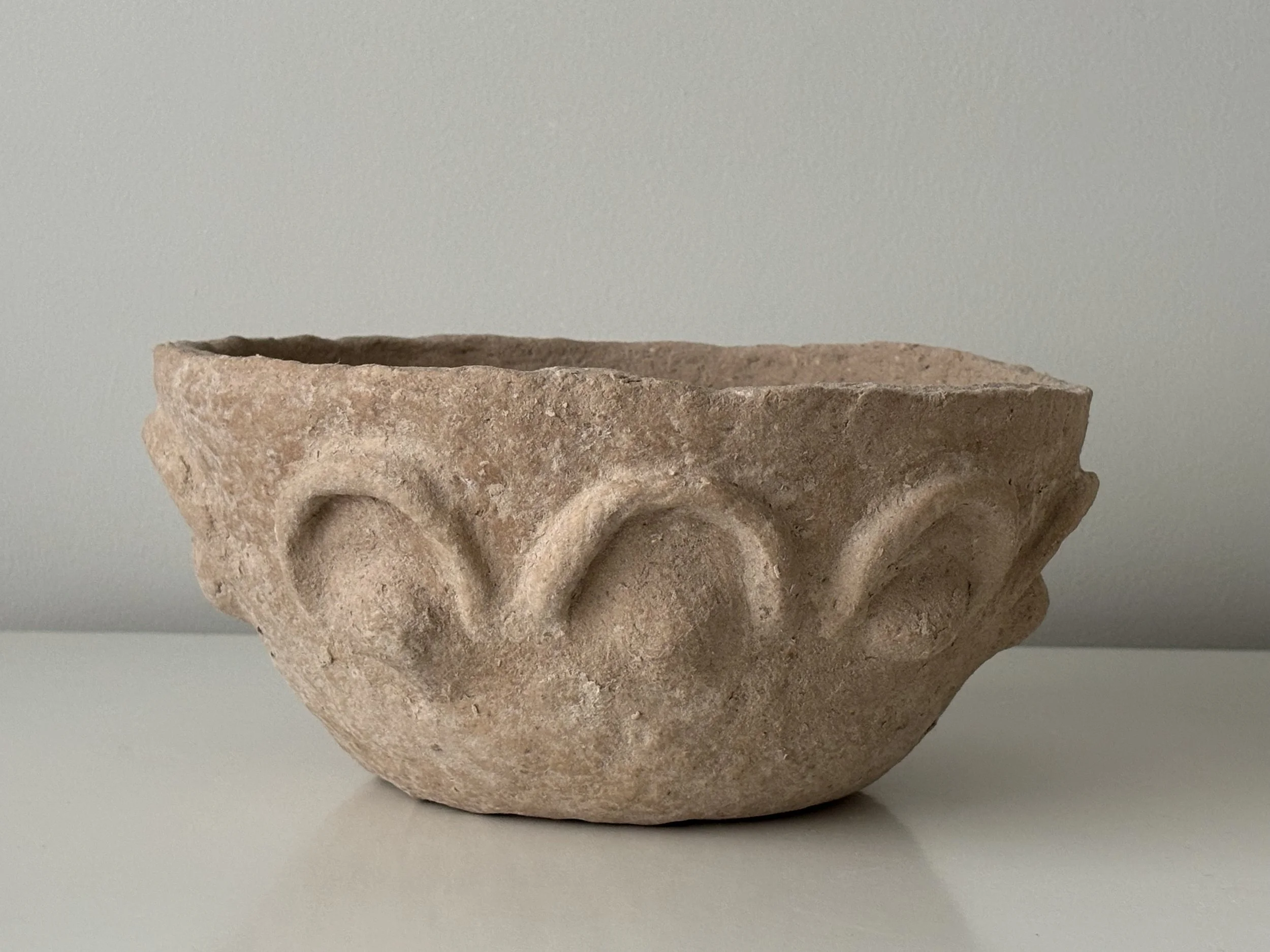 Textured Arches Bowl N.39, off-white paper clay bowl viewed from an alternate angle highlighting asymmetrical shape, from Papier Atelier London