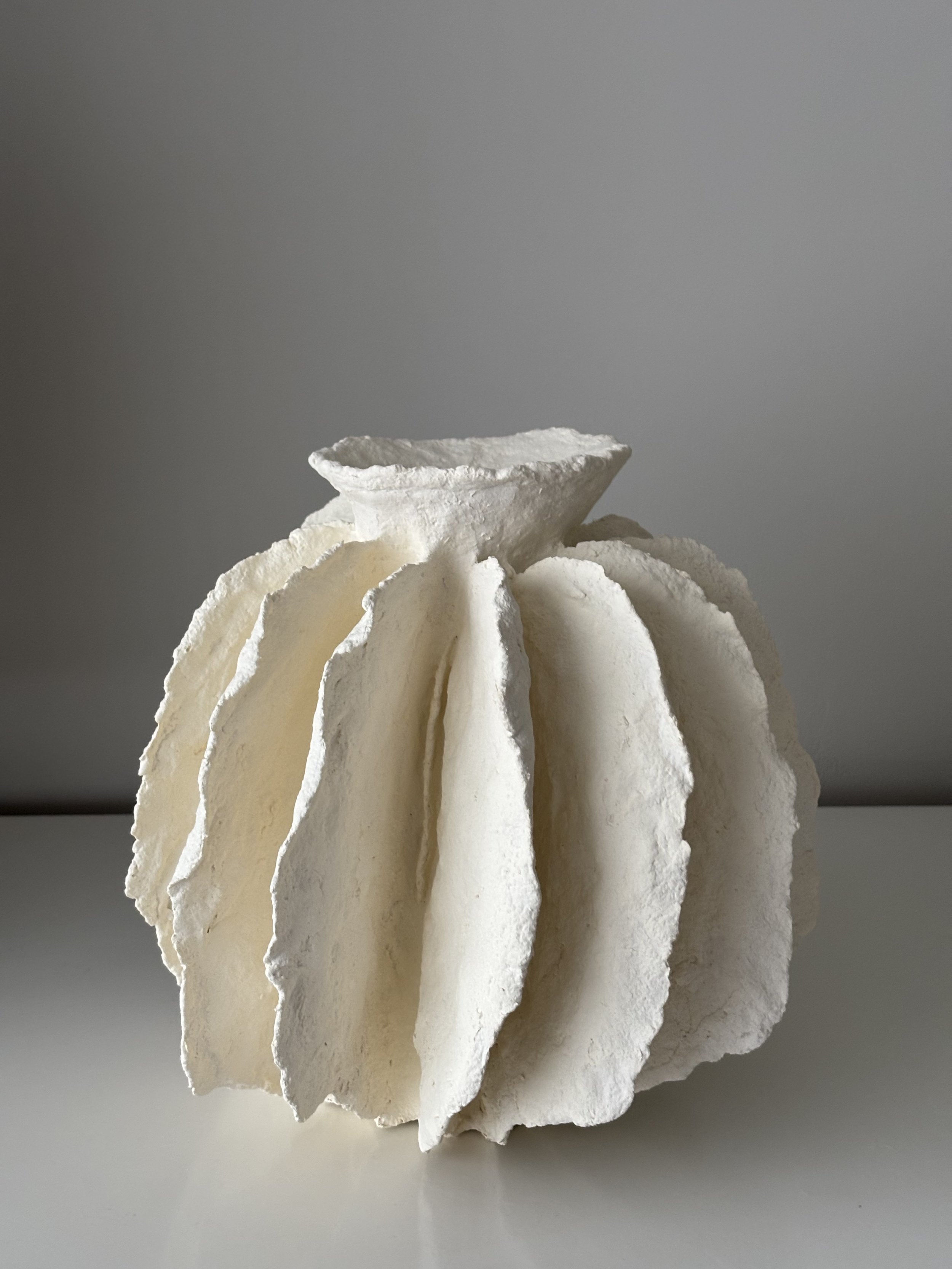 Close-up detail of White Sculptural Pleated Vessel N.43 surface texture, showing sculptural paper clay imperfections and Wabi-Sabi character