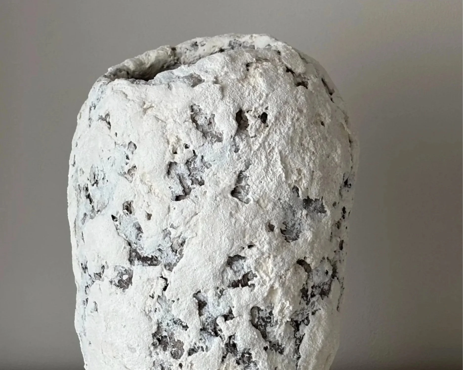 Textured White Vase N.41, white paper clay vase viewed from an alternate angle highlighting asymmetrical shape, from Papier Atelier London