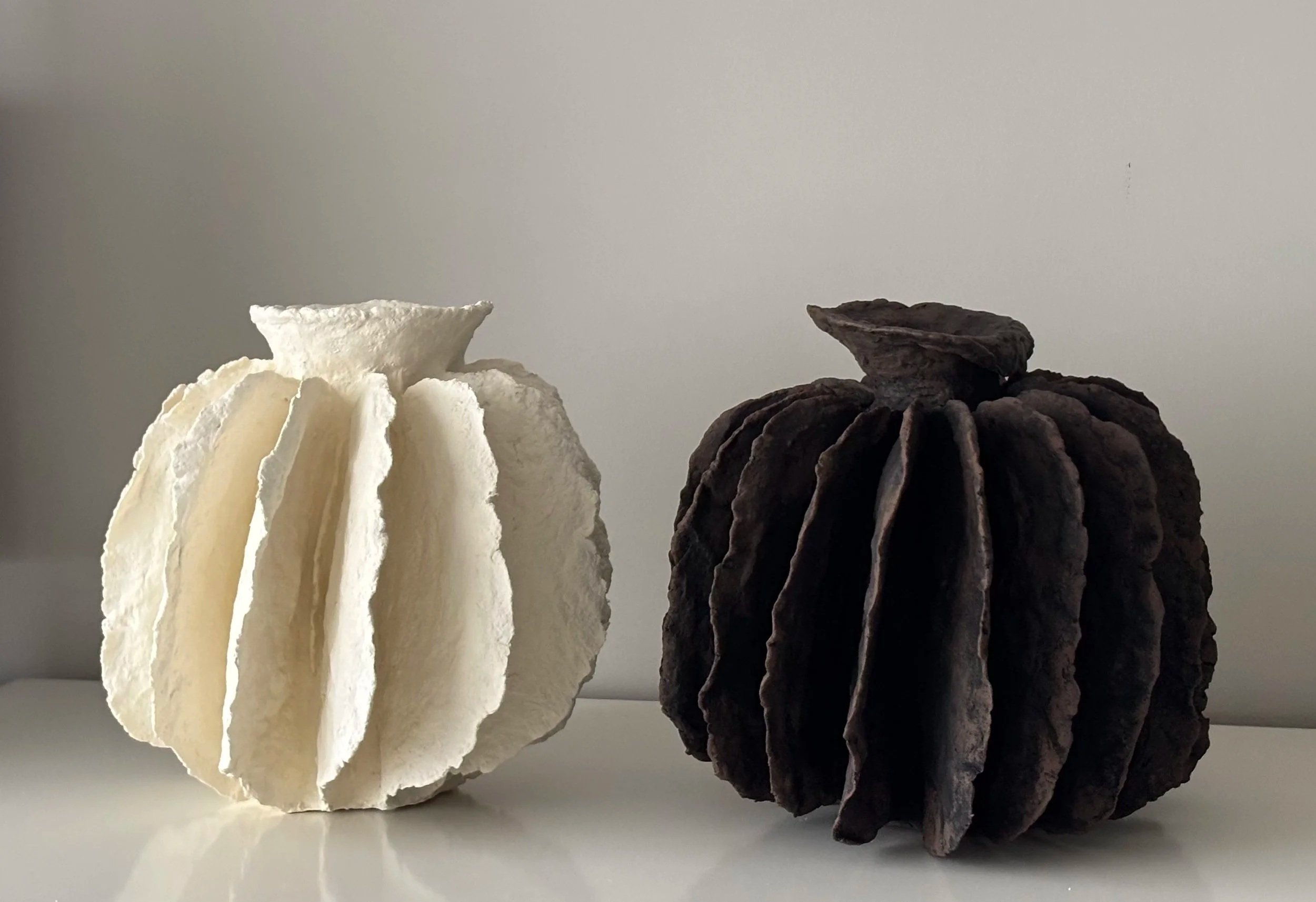 White Sculptural Pleated Vessel N.43, white paper clay vessel viewed from an alternate angle highlighting asymmetrical shape, from Papier Atelier London