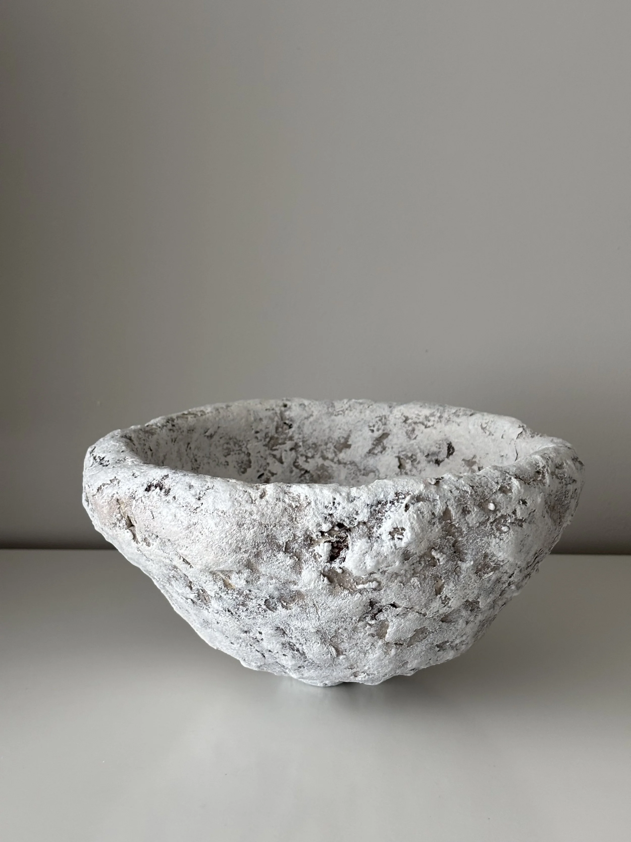 Textured Sculptural Bowl N.51, off-white paper clay bowl viewed from an alternate angle highlighting asymmetrical shape, from Papier Atelier London
