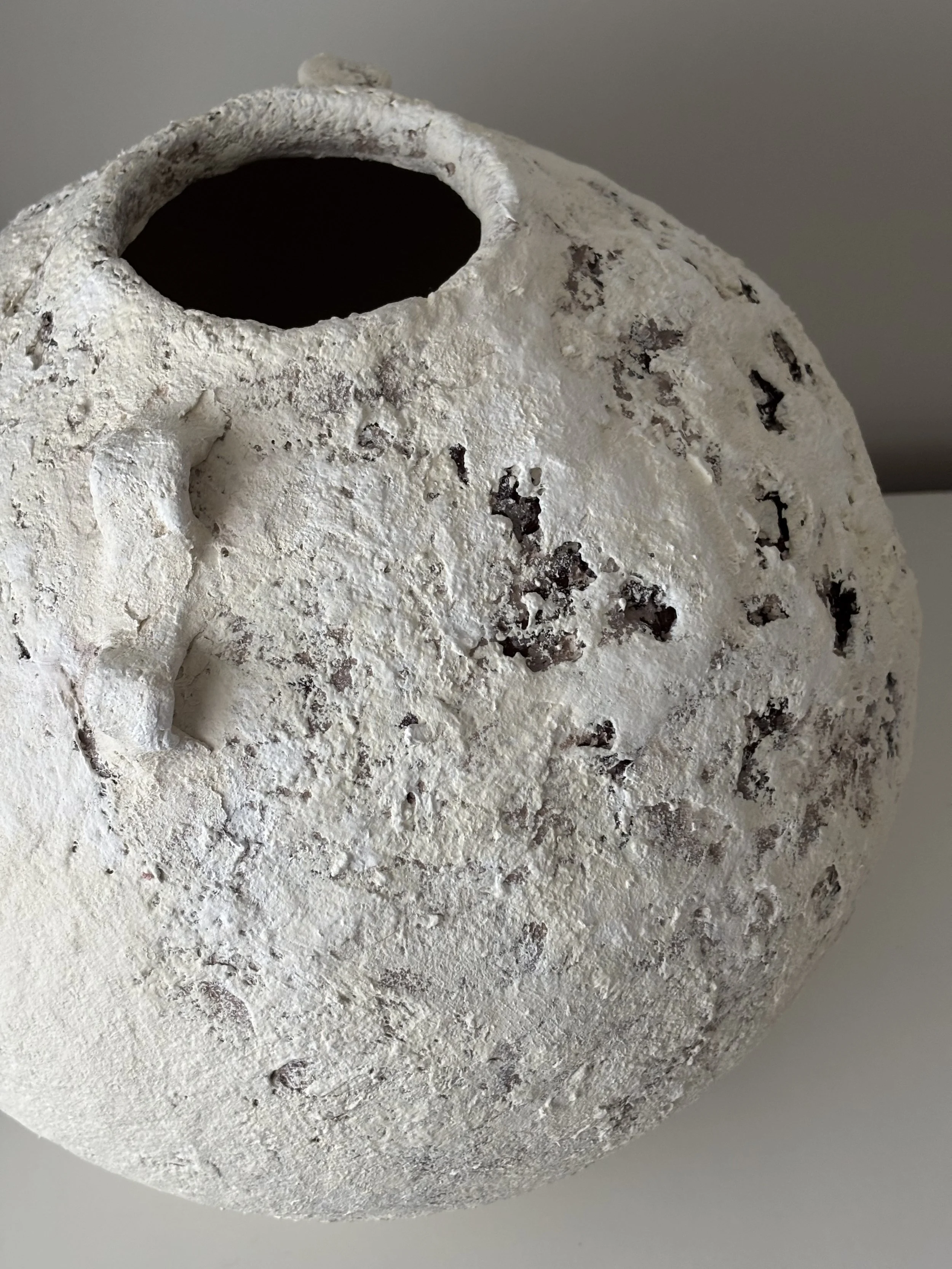 Extra Large Layered Vessel N.15, off-white paper clay vessel viewed from an alternate angle highlighting asymmetrical shape, from Papier Atelier London