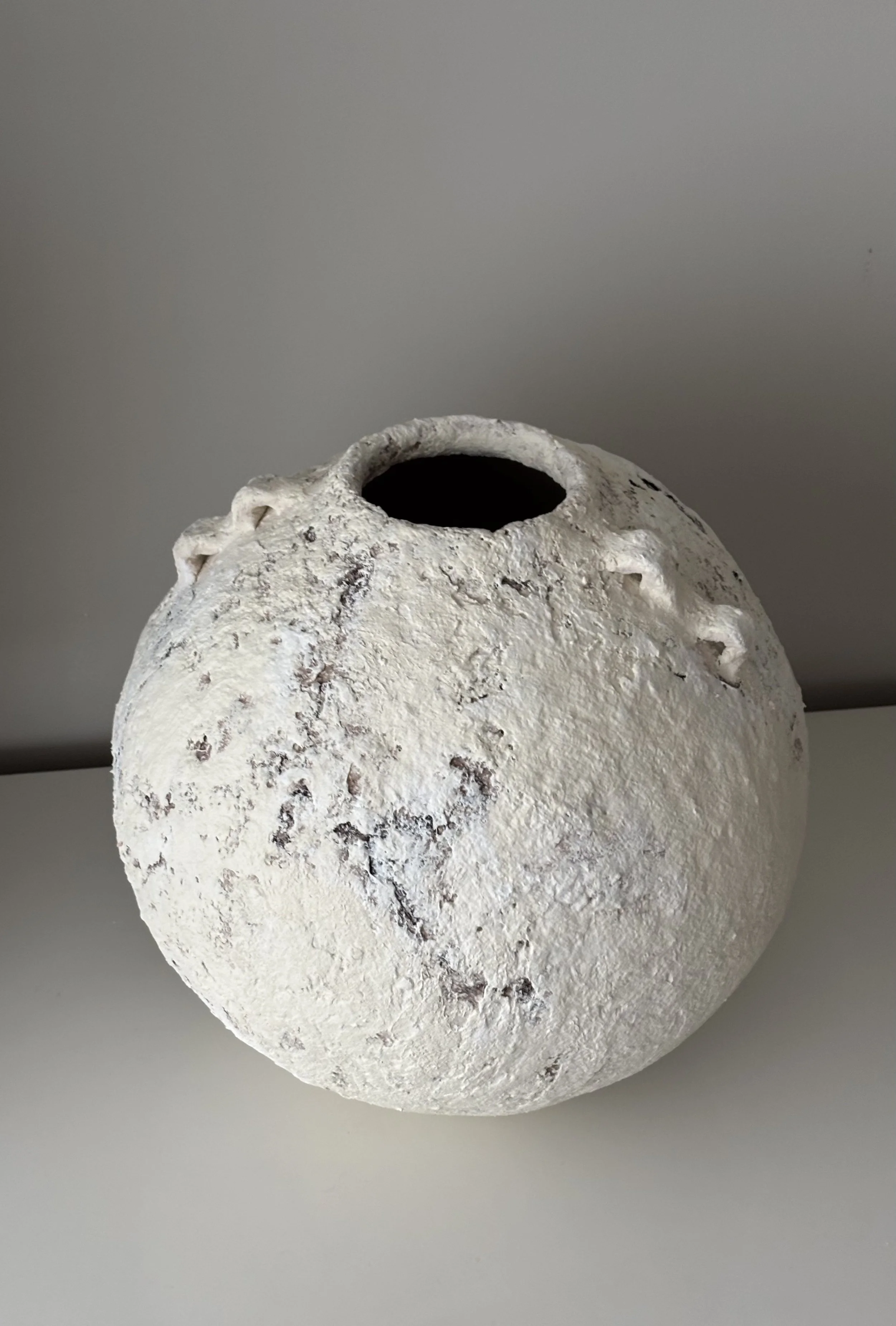 Extra Large Layered Vessel N.15 from an angled perspective, off-white handcrafted paper clay vessel with irregular organic edges, handmade in London