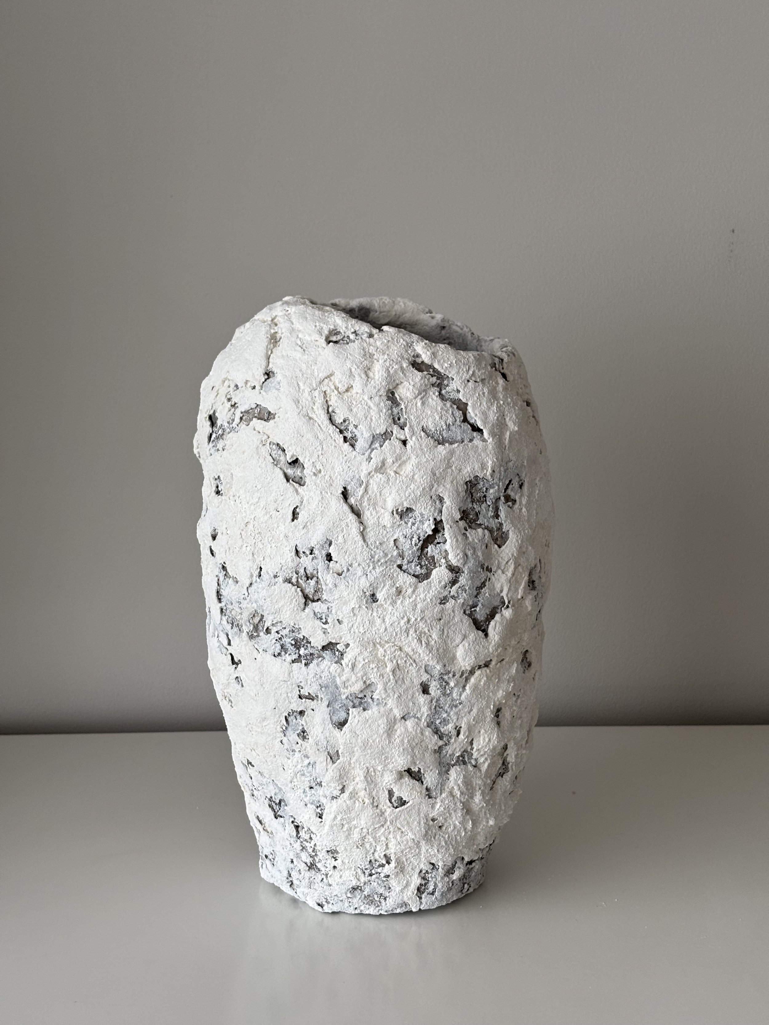 Rear view of Textured White Vase N.41 in white handcrafted paper clay, showing organic asymmetry from behind, handmade in London