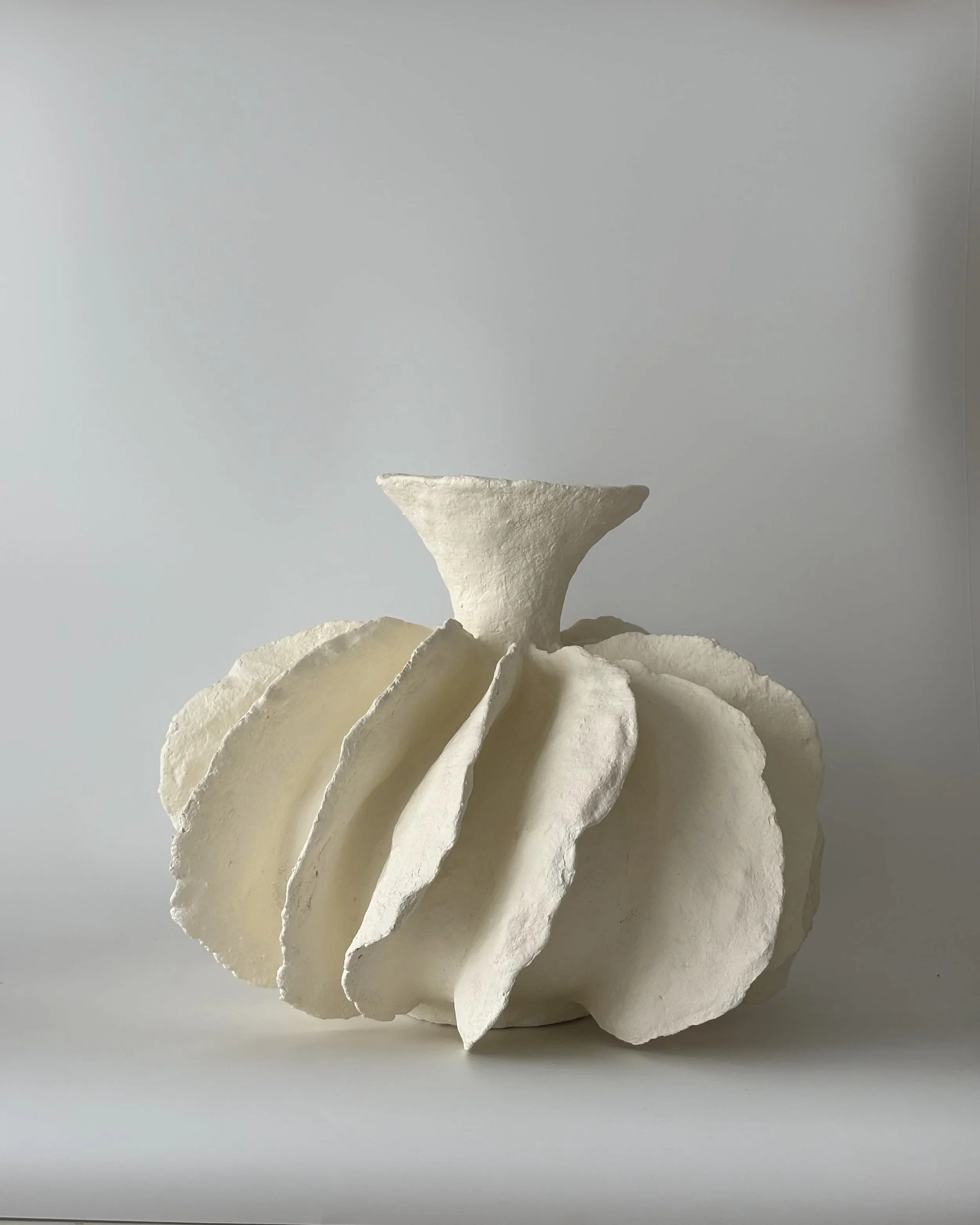 Pleated Vase N.12, handmade paper clay vase, side view. Papier Atelier London