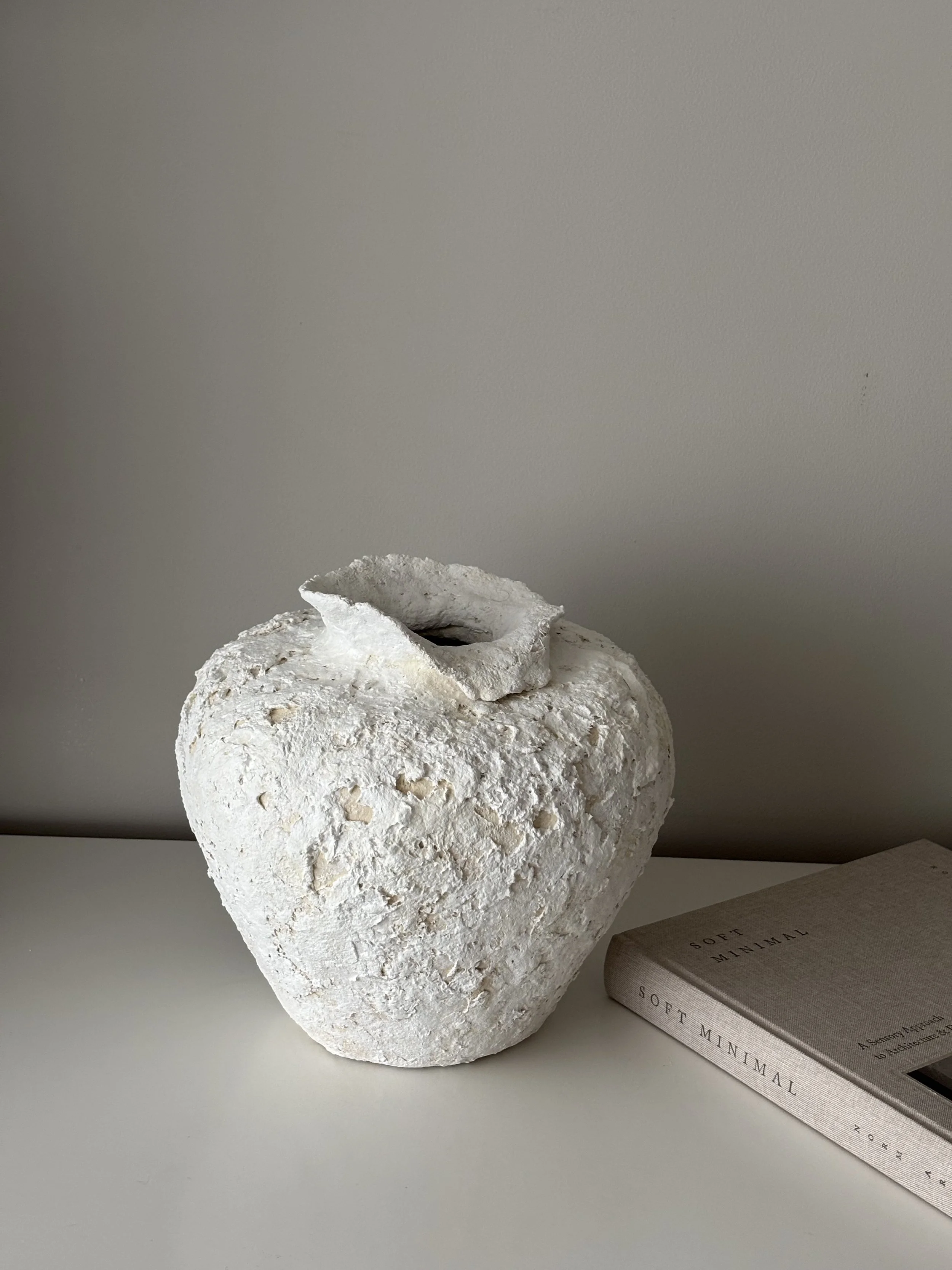 Three-quarter view of Wabi Sabi Neutral Tones Vessel N.2, neutral tones textured paper clay vessel with organic irregular form, minimalist sculptural home decor