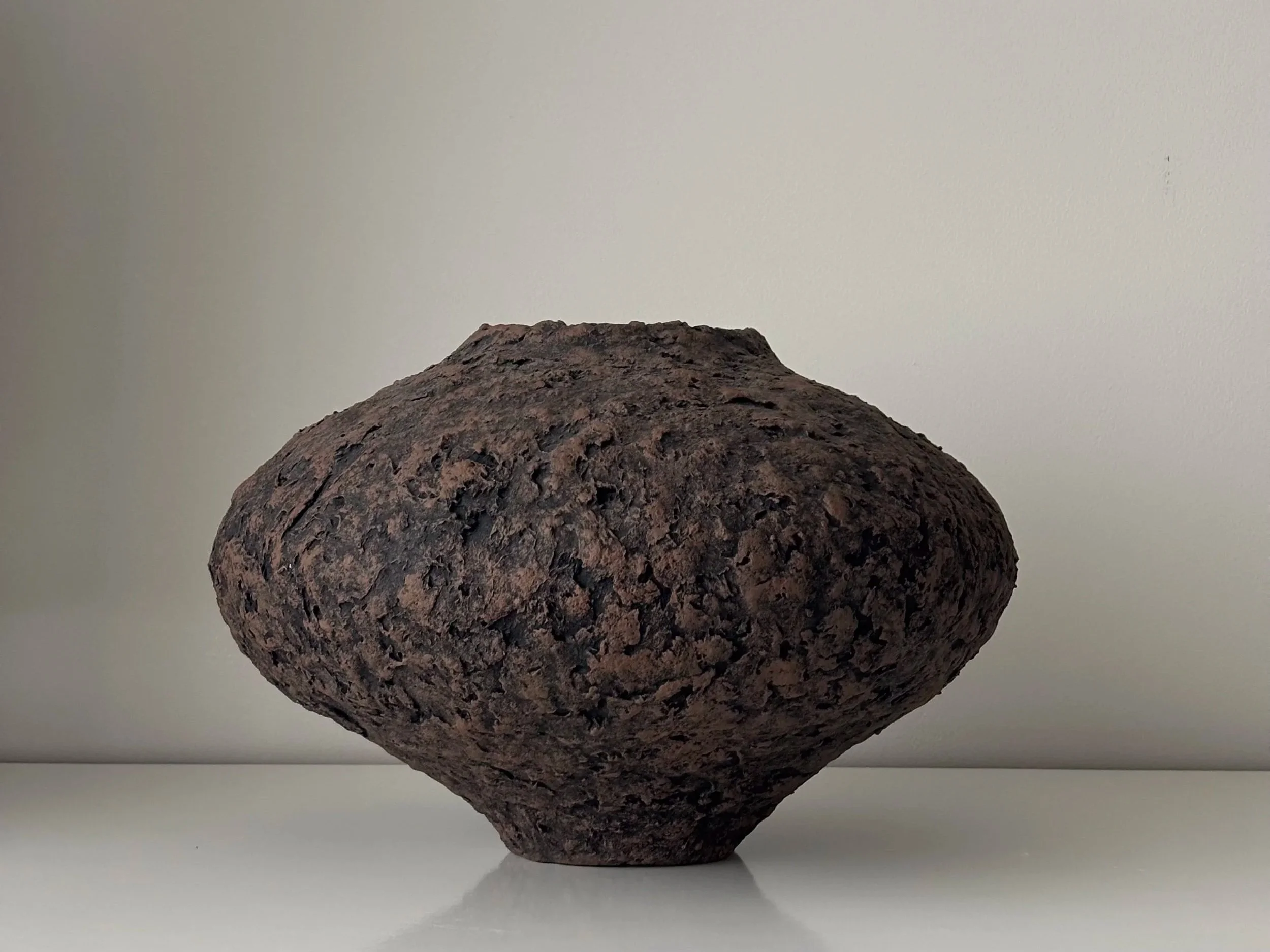 Wabi Sabi Vase N.44, off-white paper clay vase viewed from an alternate angle highlighting asymmetrical shape, from Papier Atelier London