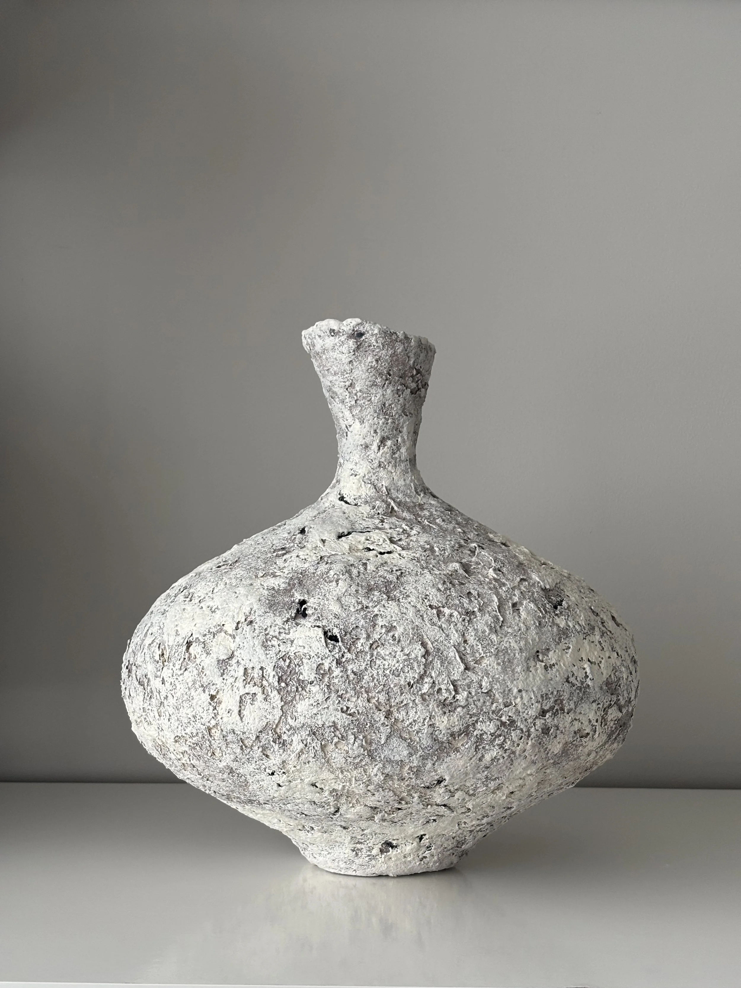 Side profile of Wabi Sabi Vase N.11 in textured paper clay, showing the sculptural silhouette and textured surface, minimalist sculptural home decor