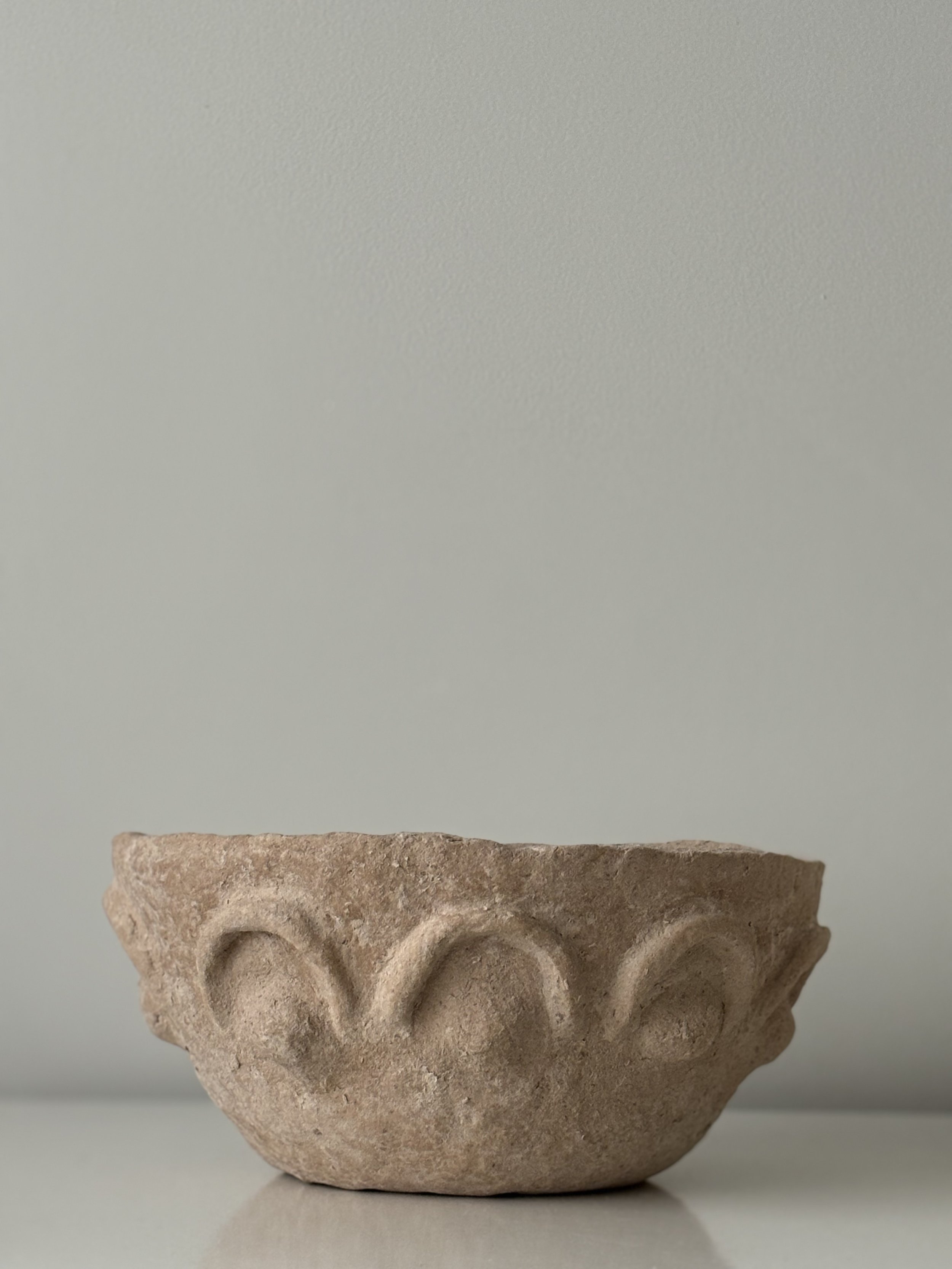 Side profile of Textured Arches Bowl N.39 in Wabi-Sabi inspired paper clay, showing the sculptural silhouette and textured surface, London atelier