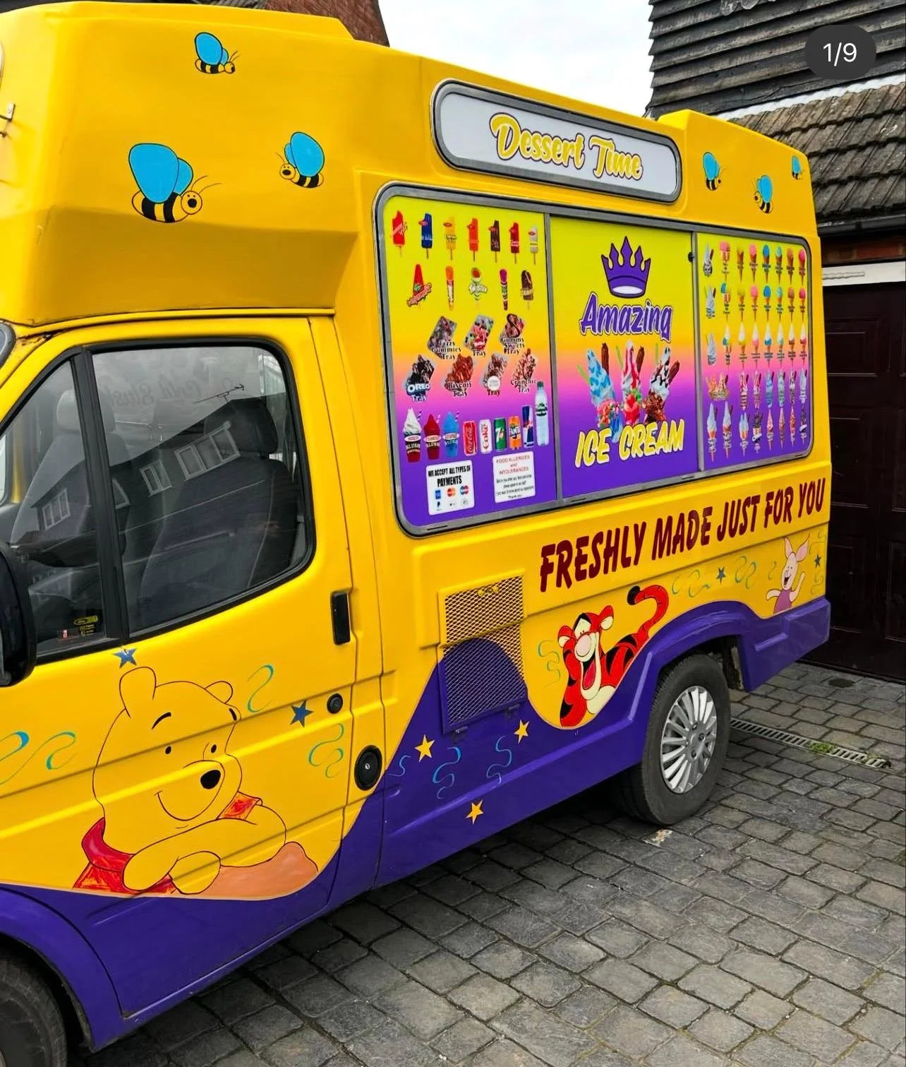 A yellow ice cream truck decorated with Winnie the Pooh and Tigger characters, illustrated with bees on the upper part. Signage on the truck reads 'Dessert Time' and 'FRESHLY MADE JUST FOR YOU'. The menu includes various ice cream treats, and the truck features colorful graphics of ice cream cones and characters, with the branding 'Amazing Ice Cream'.