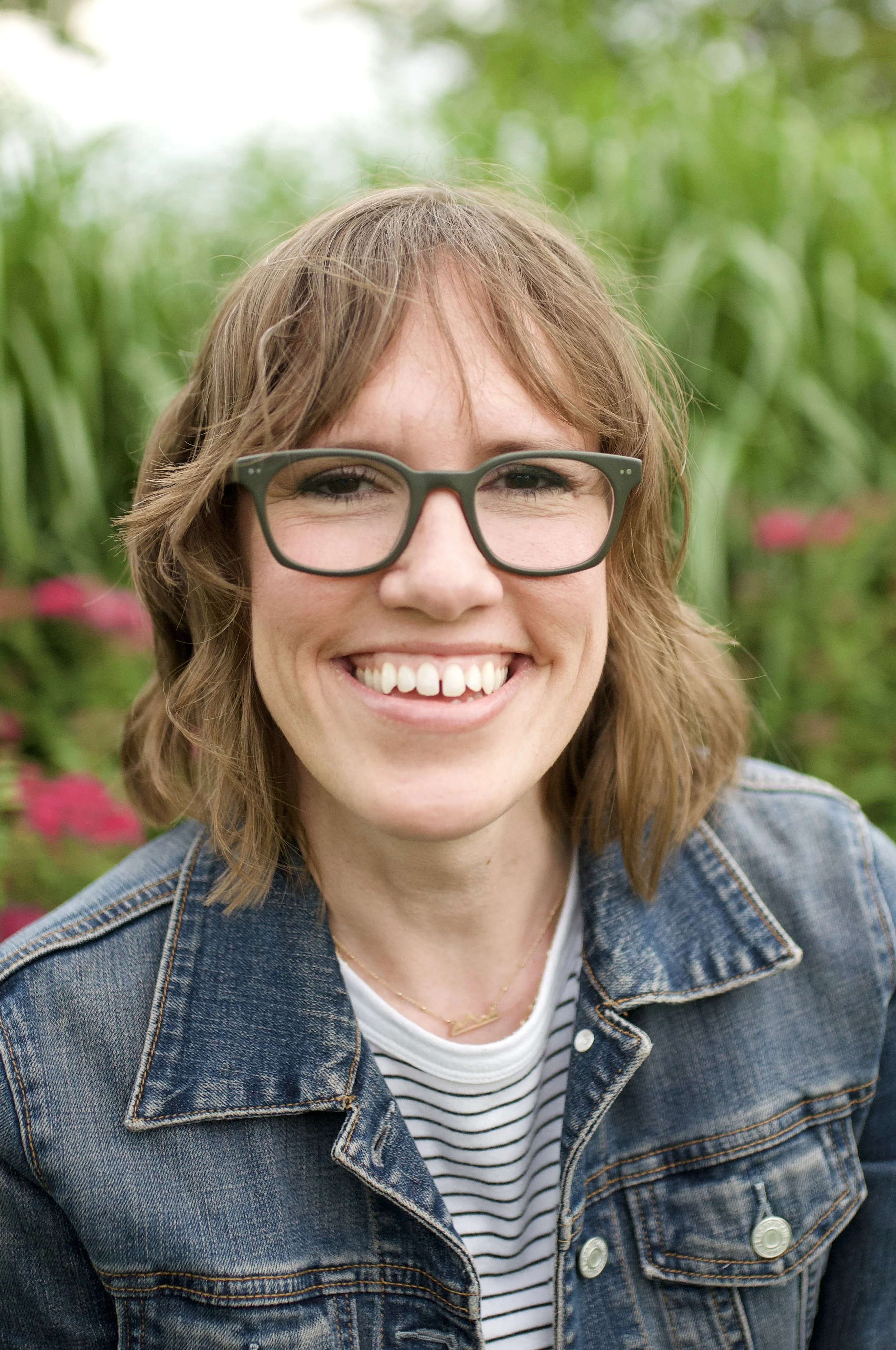 Headshot of Kara Holthaus, LCPC of Heart Centered Therapy LLC in Maryland and DMV. Kara is smiling and wearing glasses with a bright natural background, giving a welcoming and positive vibe.